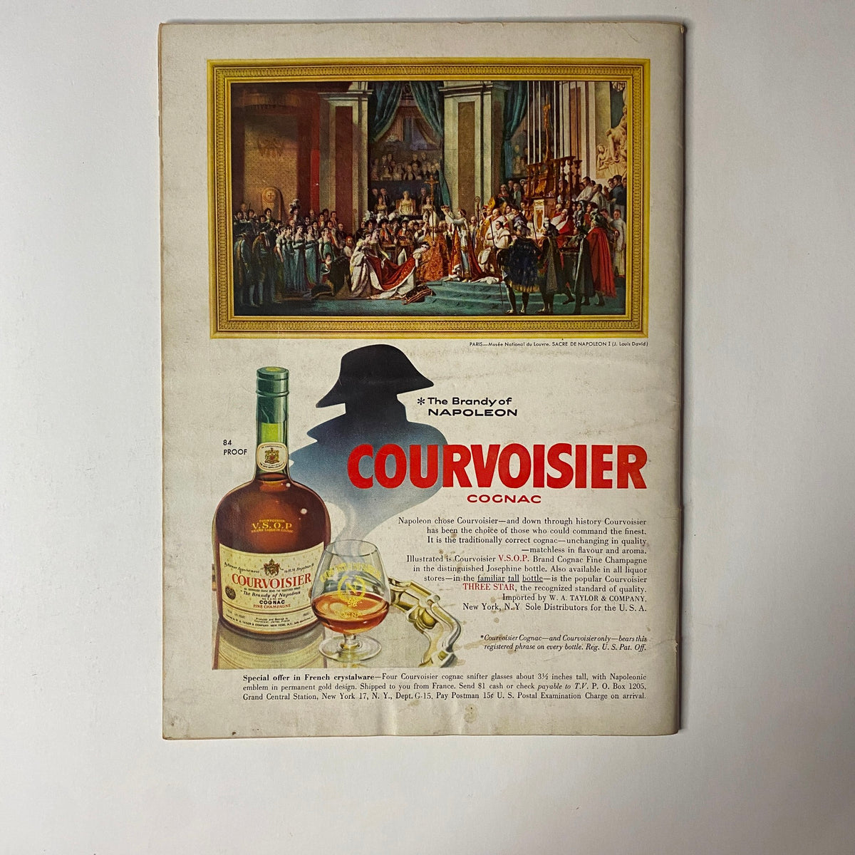 Back cover of Gourmet Magazine December 1955 depicting a colorful advertisement for Courvoisier Cognac, highlighting the brandy of Napoleon and celebrating festive occasions.