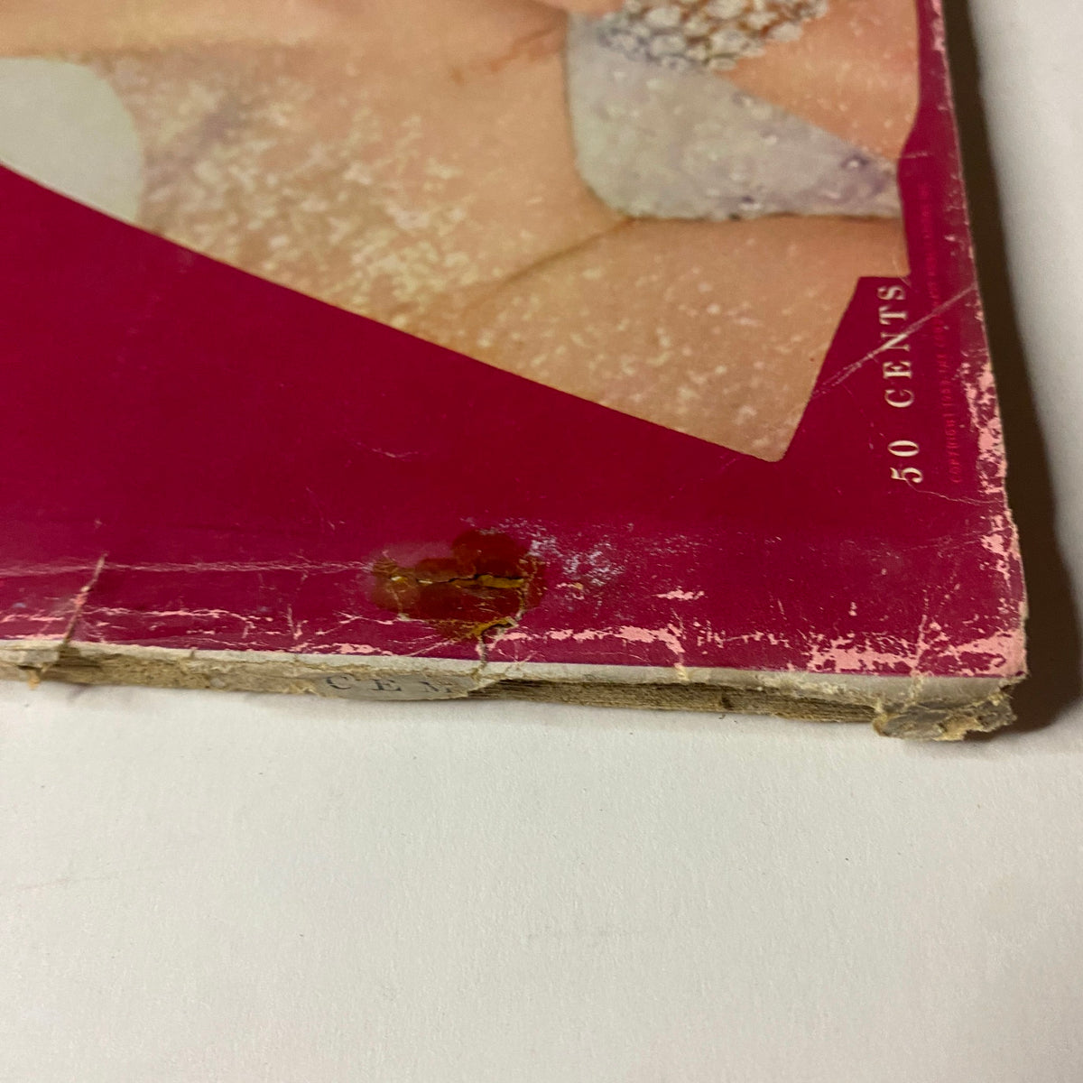 Vogue Magazine December 1953 Kathleen Wallace by Erwin Blumenfeld GD Interior showing the spine of the magazine with visible wear and a small stain.