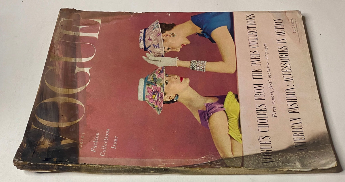 Close-up of Vogue Magazine March 1, 1954 cover depicting Mary Jane Russell and Cherry Nelms, focusing on fashion trends from Paris collections. The magazine shows signs of wear but remains a collectible item.