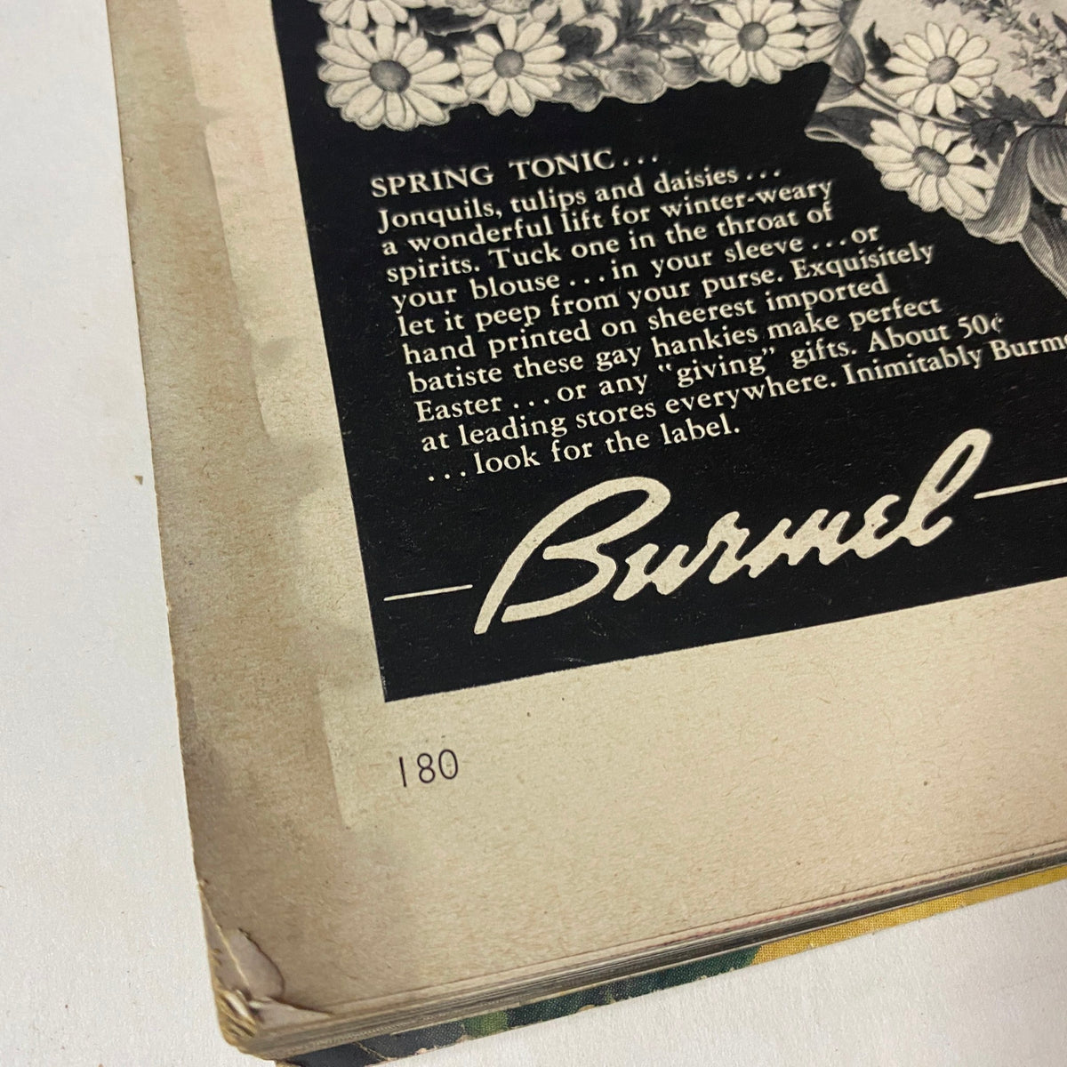 Vogue Magazine March 1, 1954 with a close-up of a Burmel advertisement for spring tonic, displaying floral designs and promotion for seasonal gifts, emphasizing vintage marketing from the era.
