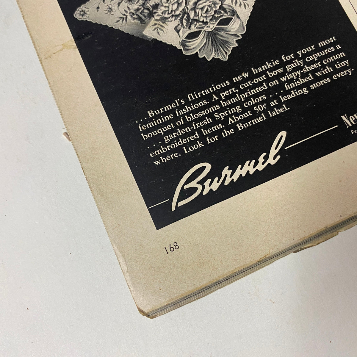 Vogue Magazine January 1952 Suzy Parker by Erwin Blumenfeld GD Interior - Advertisement for Burnel featuring a floral handkerchief and fashion accessories. Page 168.