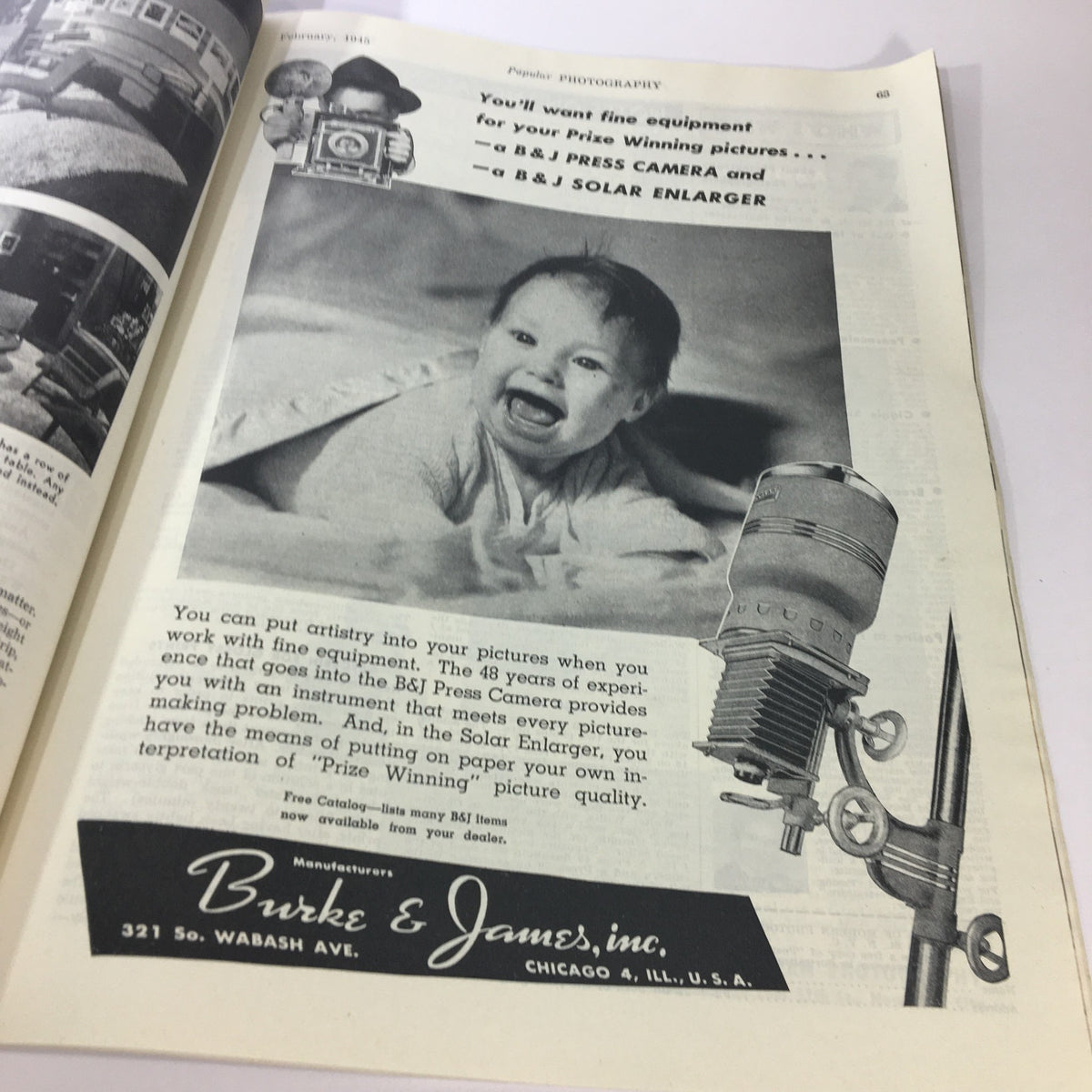 Advertisement from VTG Popular Photography Magazine February 1945 showcasing a happy baby and B&J Press Camera equipment. This issue features George Bernard Shaw on the cover.