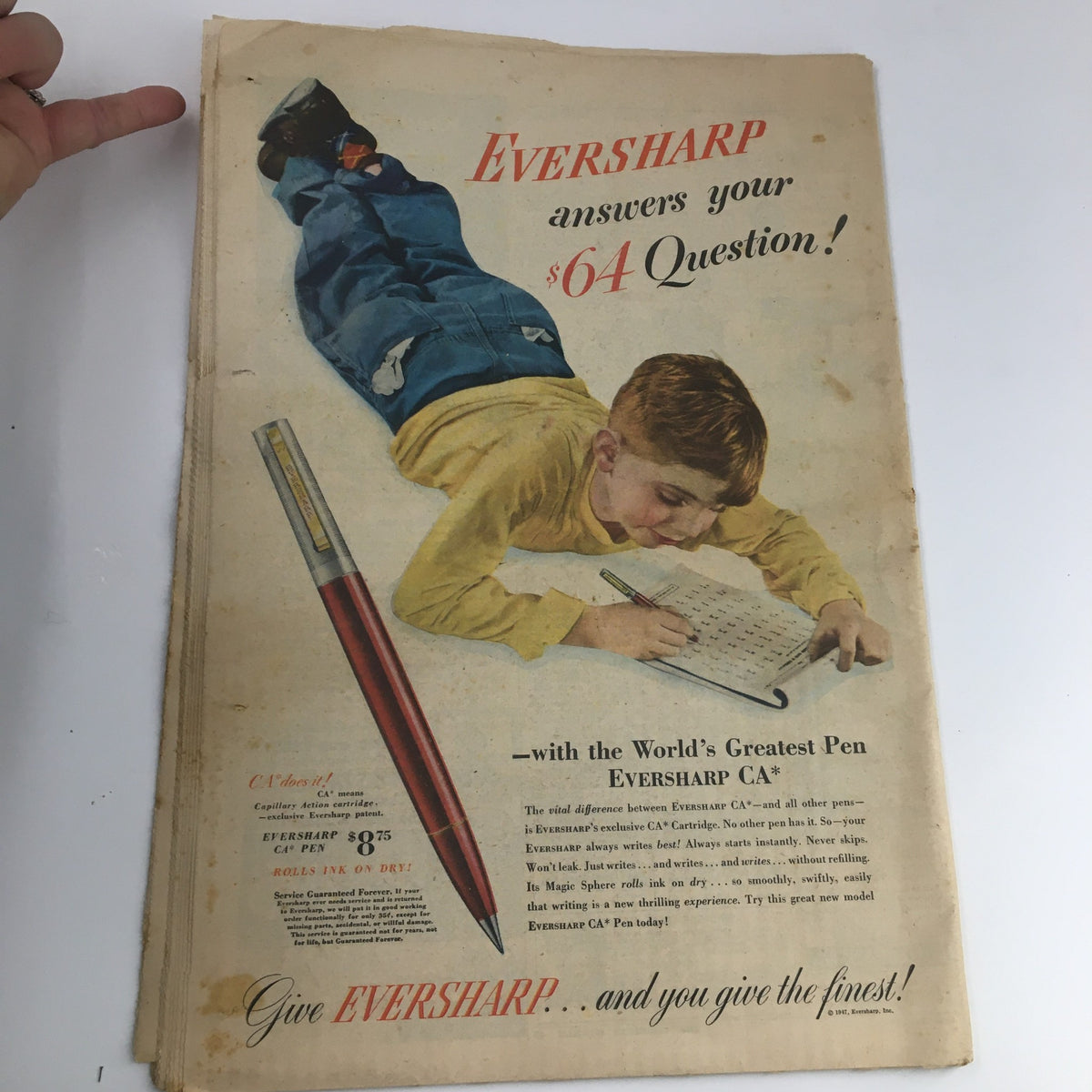 Advert for Eversharp pen featured in The American Weekly Magazine June 8 1947, showing a boy writing on the floor with the Eversharp pen and the slogan 'answers your $64 Question!'. Highlights classic nostalgic advertising.