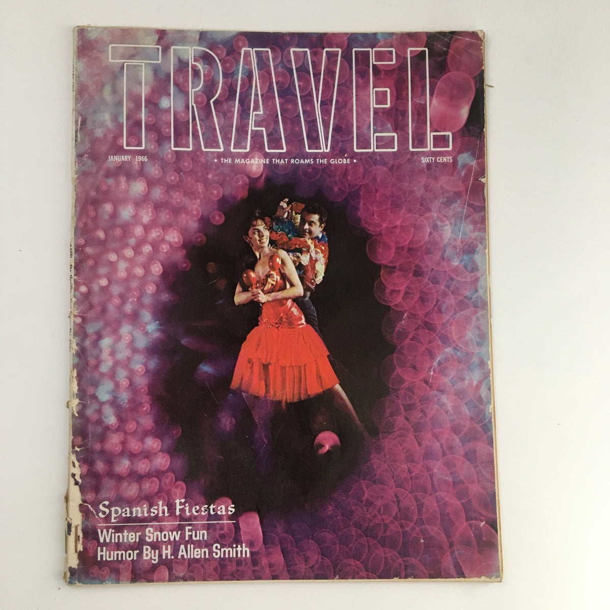 Cover of VTG Travel Magazine January 1966 featuring winter snow fun and humor by H Allen Smith. Colorful and vintage design with a couple depicted in vibrant attire.