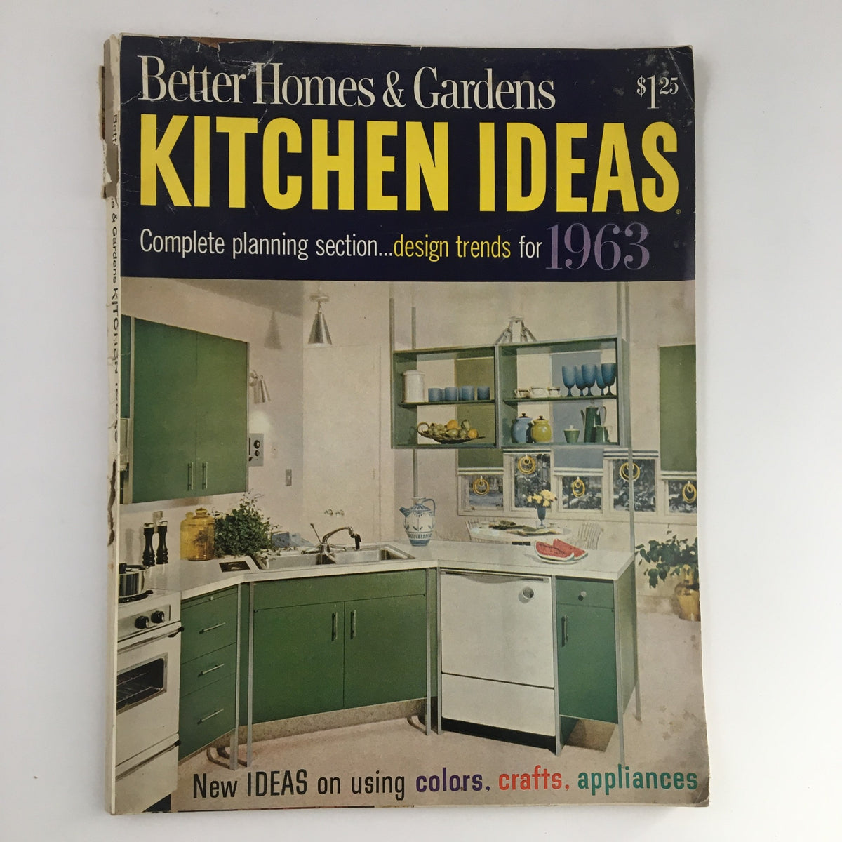 Cover of Better Homes & Gardens Magazine titled Kitchen Ideas for 1963 showcasing mid-century kitchen design with green cabinetry and modern appliances.