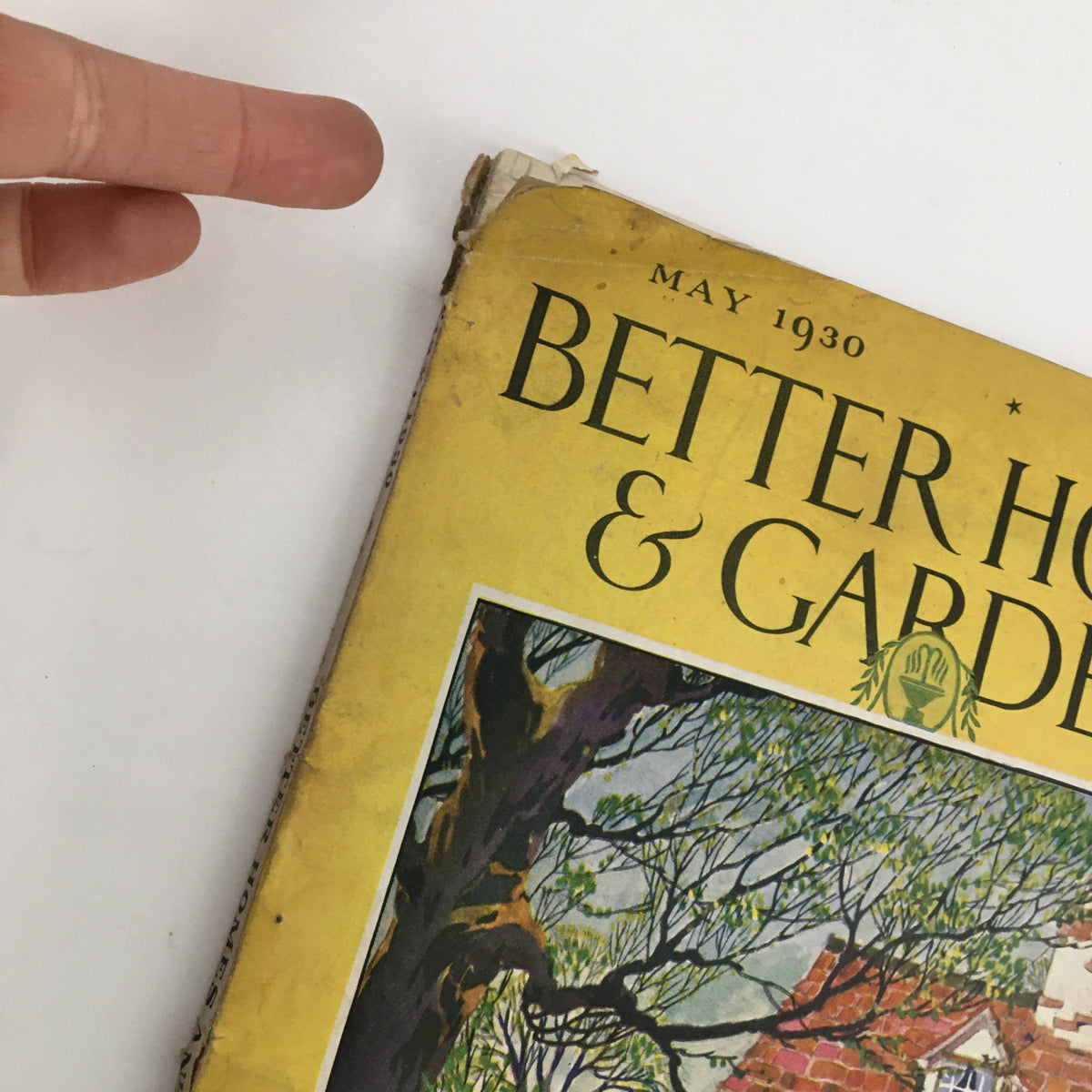 Close-up of the top corner of Better Homes & Gardens May 1930 issue, highlighting wear and the title 'Better Homes & Gardens' with vintage aesthetic.