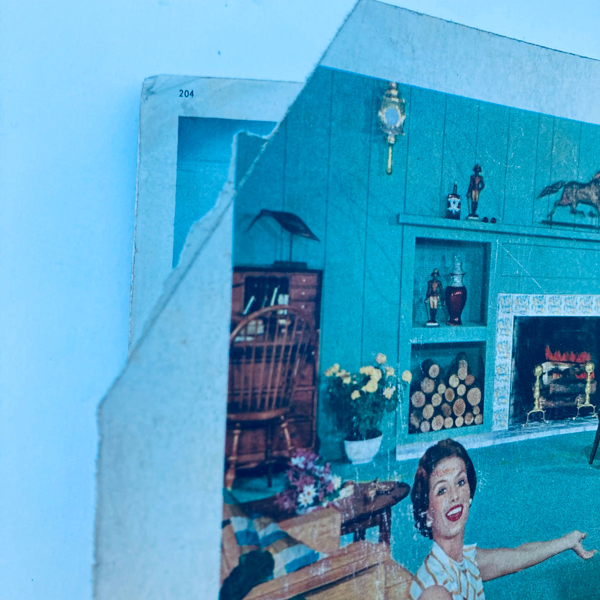 Close-up of a vintage page from House Beautiful Magazine June 1957, showing a decorated living space and a smiling woman, illustrating mid-century home decor.