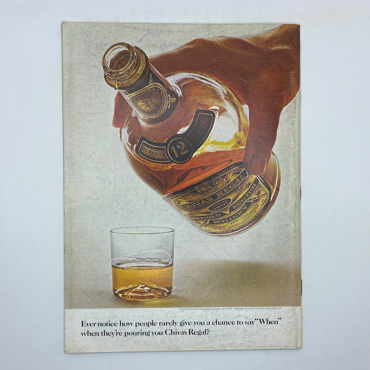 Advertisement showing a hand pouring Chivas Regal 12-Year-Old Scotch whisky into a glass, with the caption questioning why people rarely give you a chance to say 'When' while pouring.