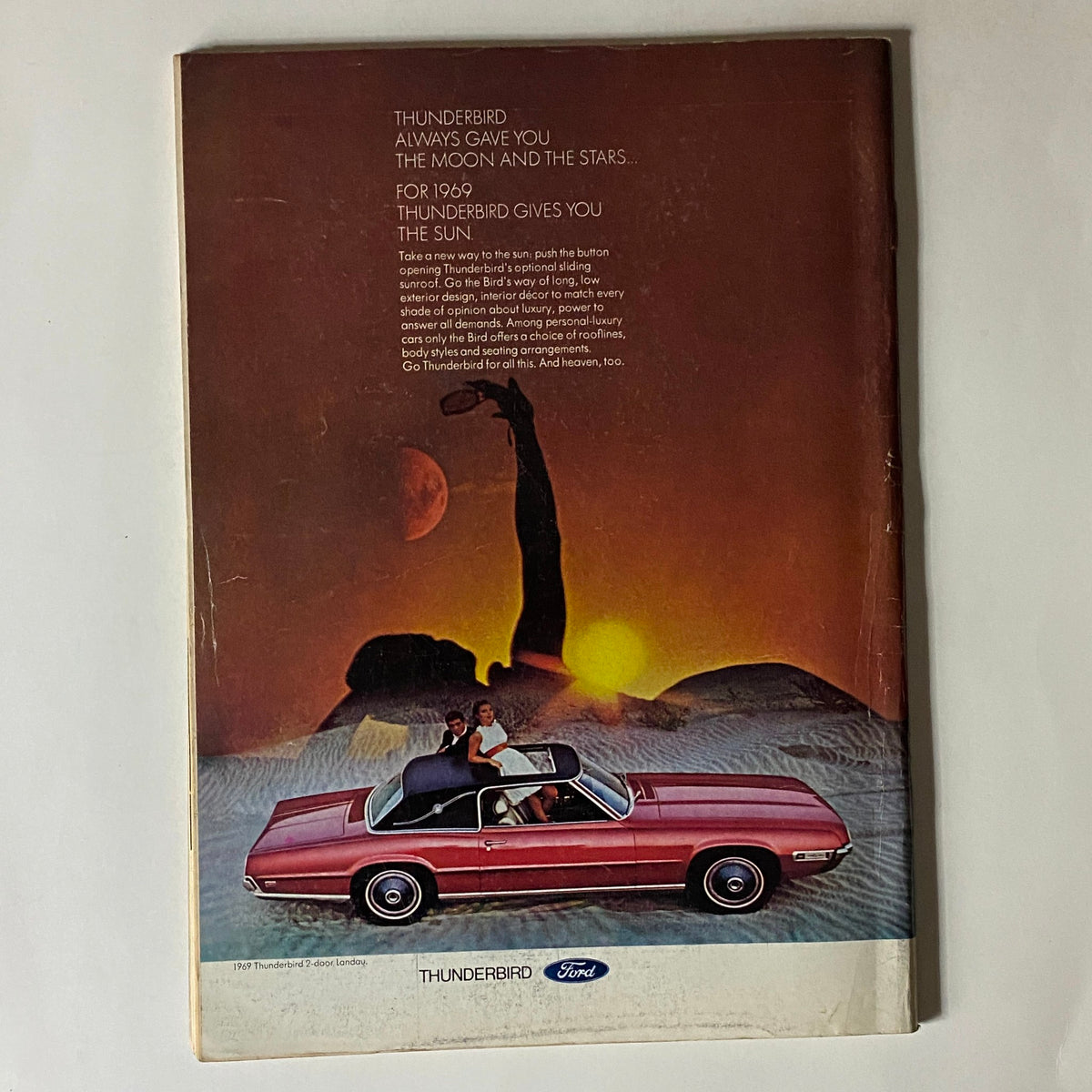 The New Yorker Complete Magazine March 8, 1969 with a Ford Thunderbird advertisement featuring a couple in a pink Thunderbird convertible against a sunset backdrop, showcasing the luxurious design and elements of the 1969 Thunderbird model.