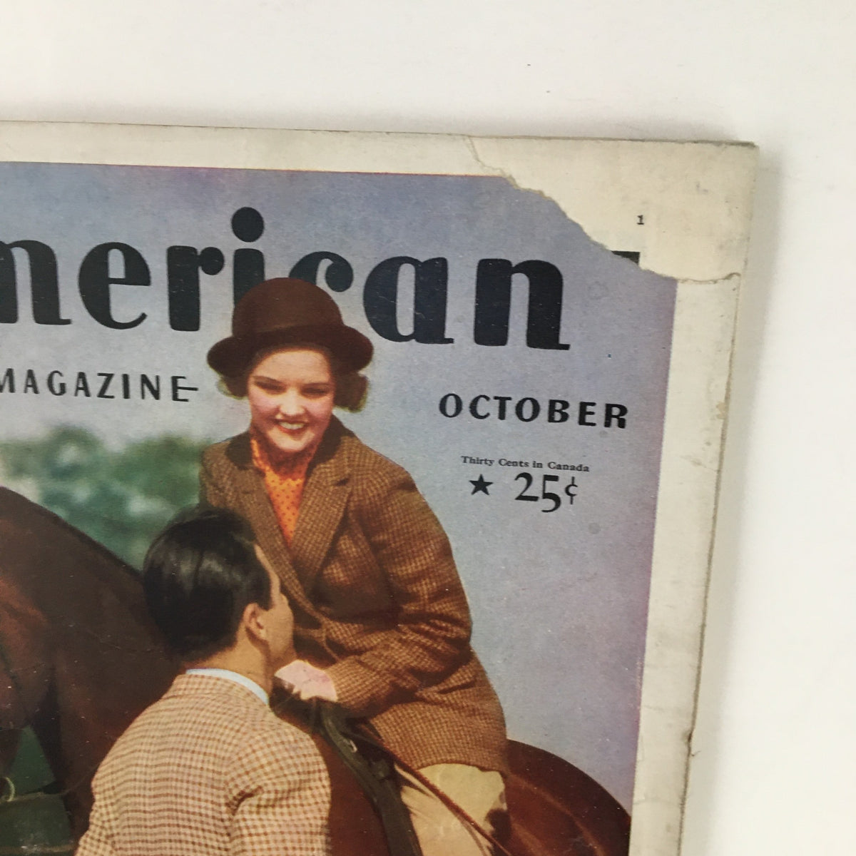 Close-up of the cover of VTG The American Magazine October 1935 featuring The Captive Bride Part I with a woman and a man, highlighting the vintage design.