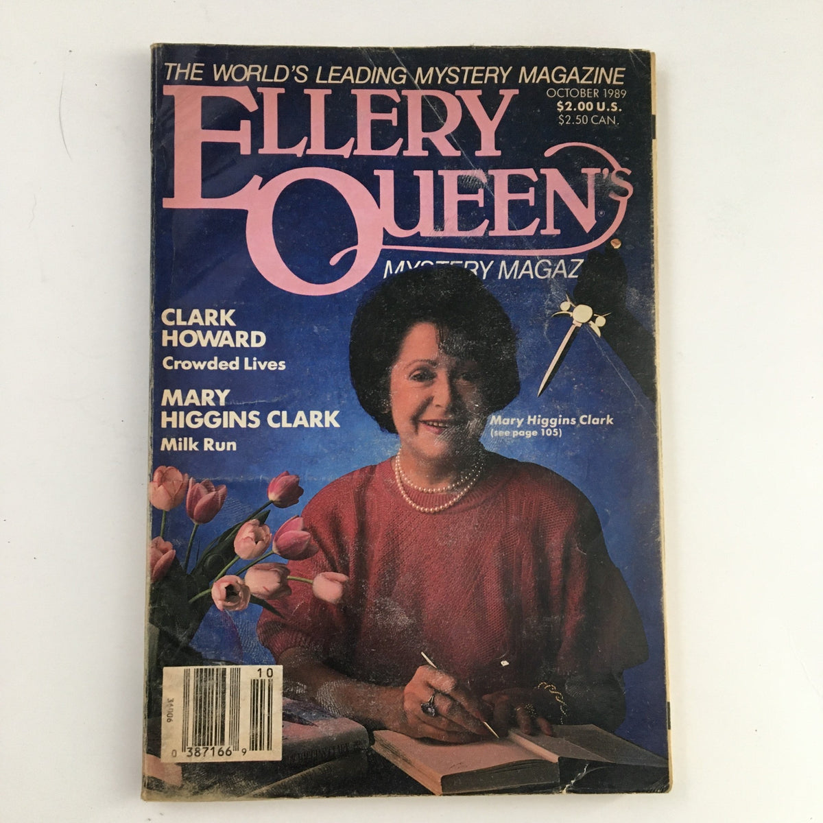 Cover of Ellery Queen's Mystery Magazine October 1989 featuring Mary Higgins Clark. The magazine showcases articles including 'Crowded Lives' and 'Milk Run' with a backdrop of purple and floral imagery.
