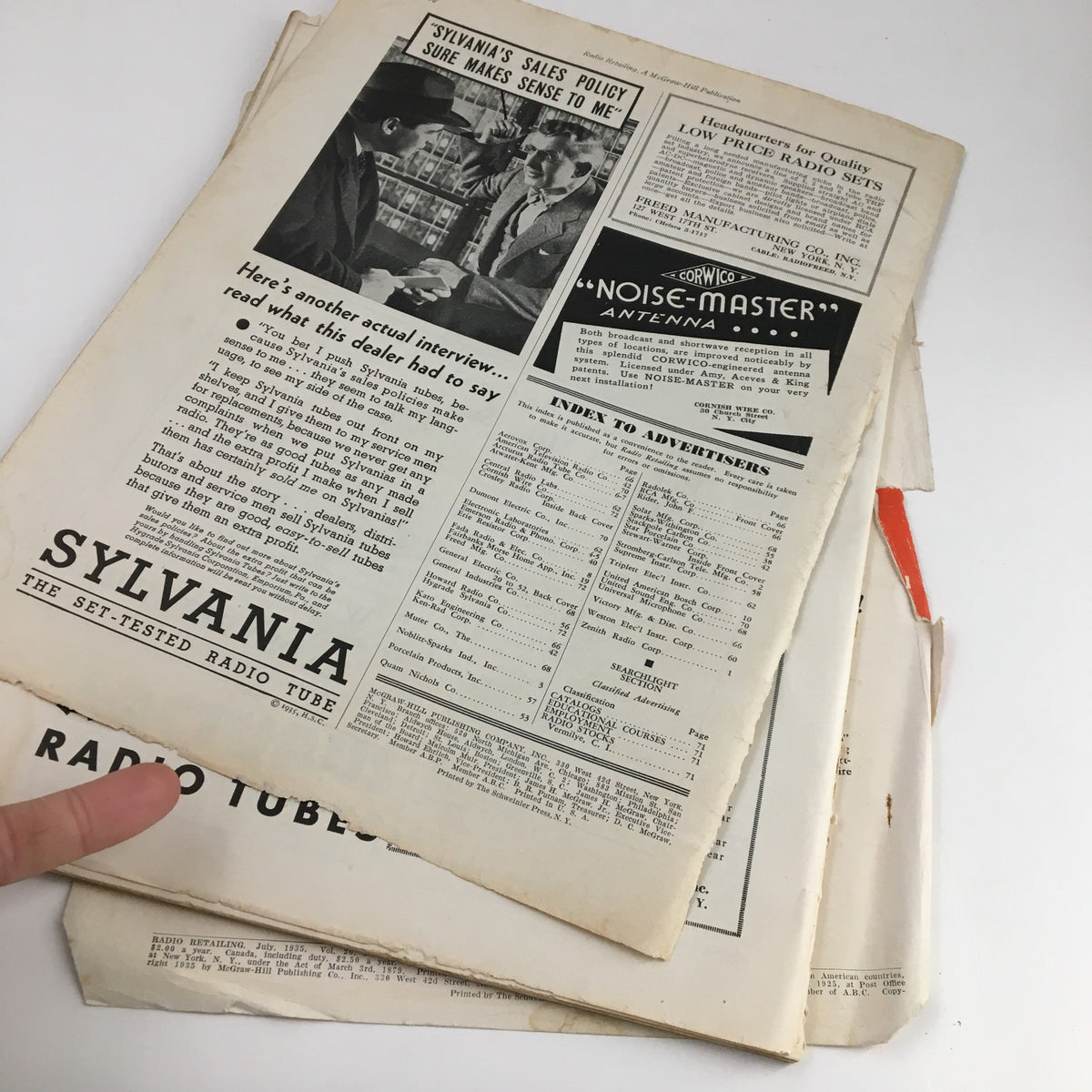 Back side view of the pages inside Radio Retailing Magazine July 1935, featuring advertisements for Sylvania radio tubes and the index for advertisers.