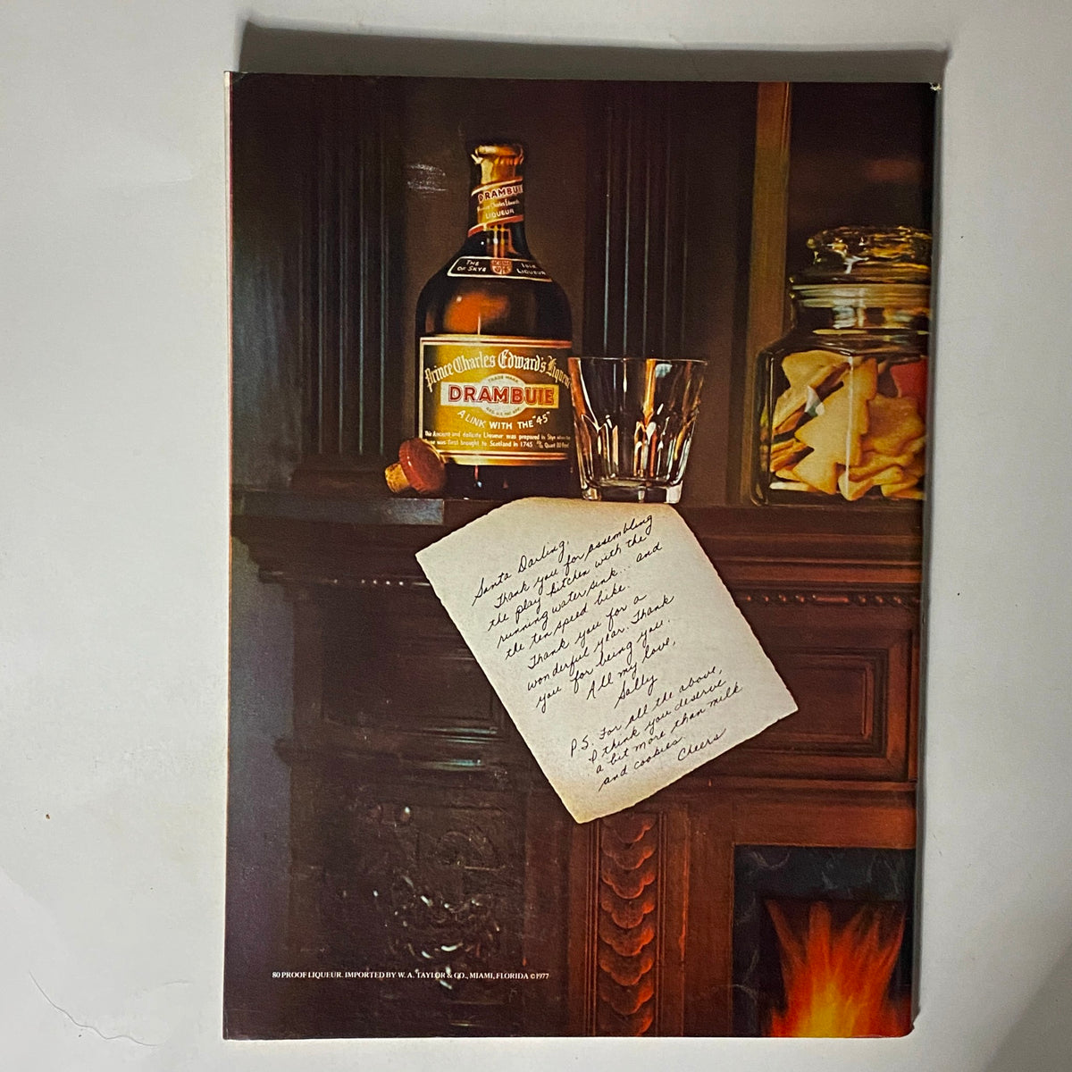 Back cover of The New Yorker Complete Magazine, December 19, 1977, featuring an advertisement for Drambuie and a handwritten note on a decorative background.
