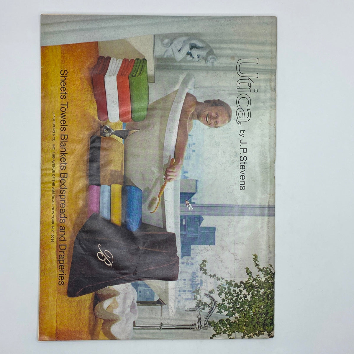 Back cover of The New Yorker Complete Magazine January 5, 1976 featuring an advertisement for Utica by J.P. Stevens, showcasing home textiles like sheets, towels, and blankets in vibrant colors.