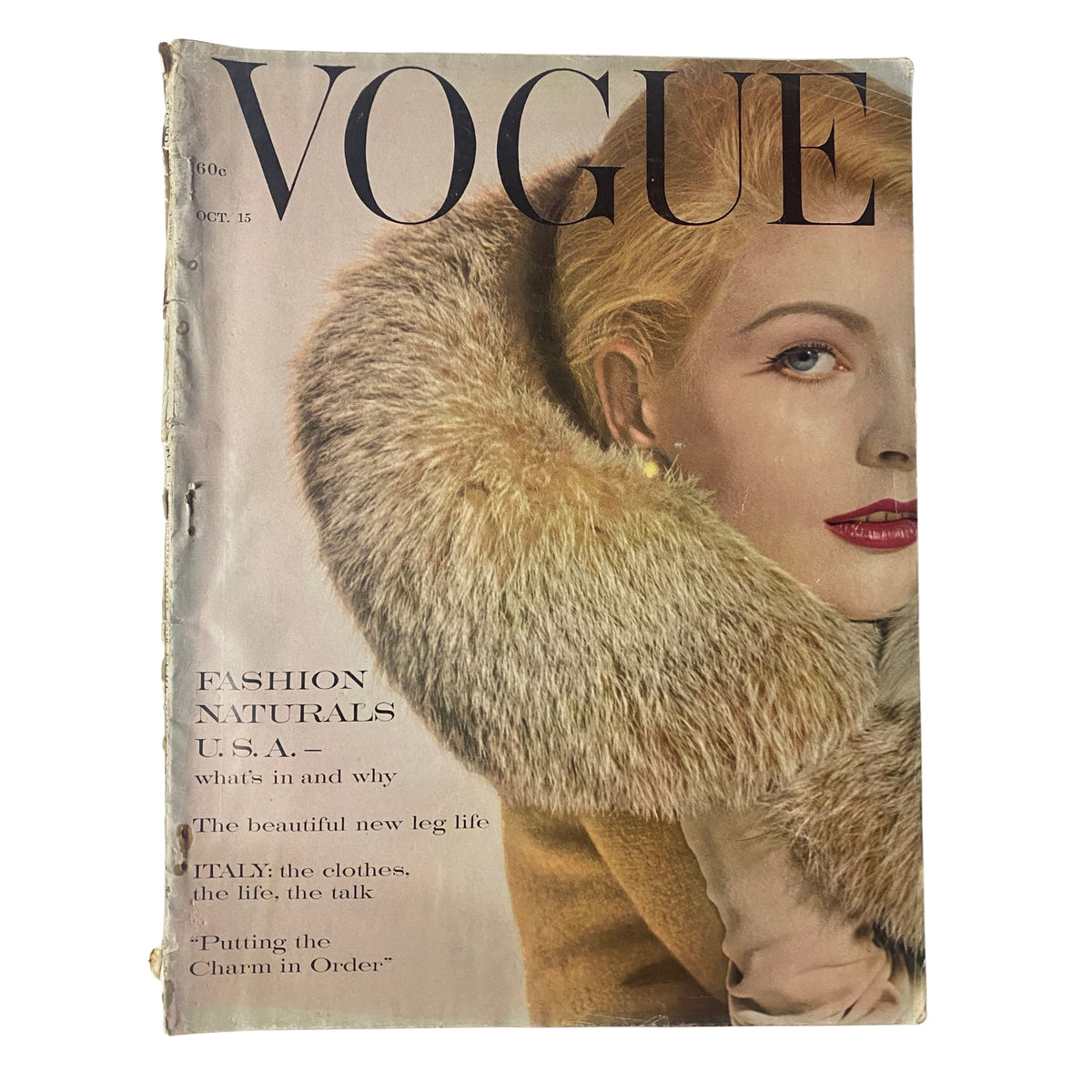 Vogue Magazine cover from October 15, 1960 featuring Angela Howard by Tom Palumbo, showcasing fashion with a fur collar and bright red lips, highlighting articles on Fashion Naturals and the latest trends.