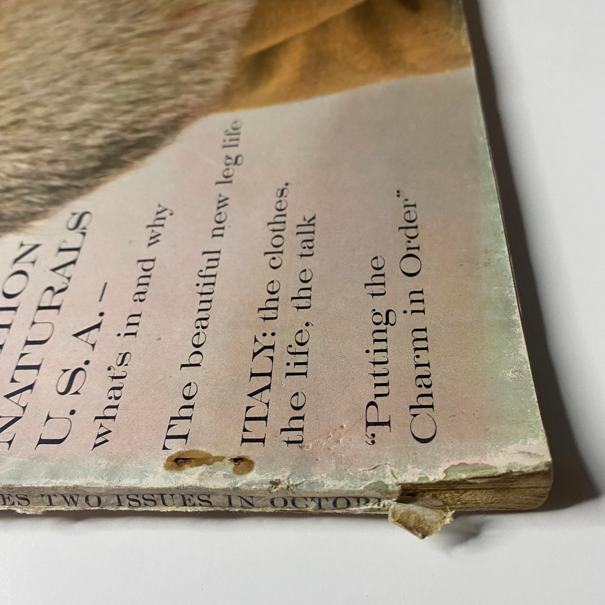 Side view of the October 15, 1960 issue of Vogue Magazine, showcasing the tattered cover and spine with details on the featured articles including fashion highlights from the era.