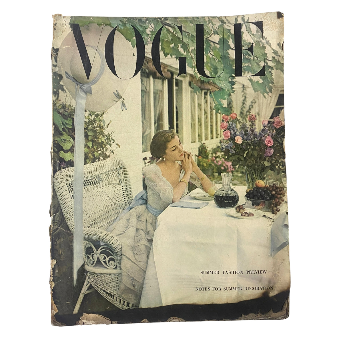 Vintage Vogue Magazine cover from April 1, 1948 featuring a Summer Fashion Preview, showcasing a woman in elegant attire seated at a table surrounded by flowers, captured by photographer Horst P. Horst.