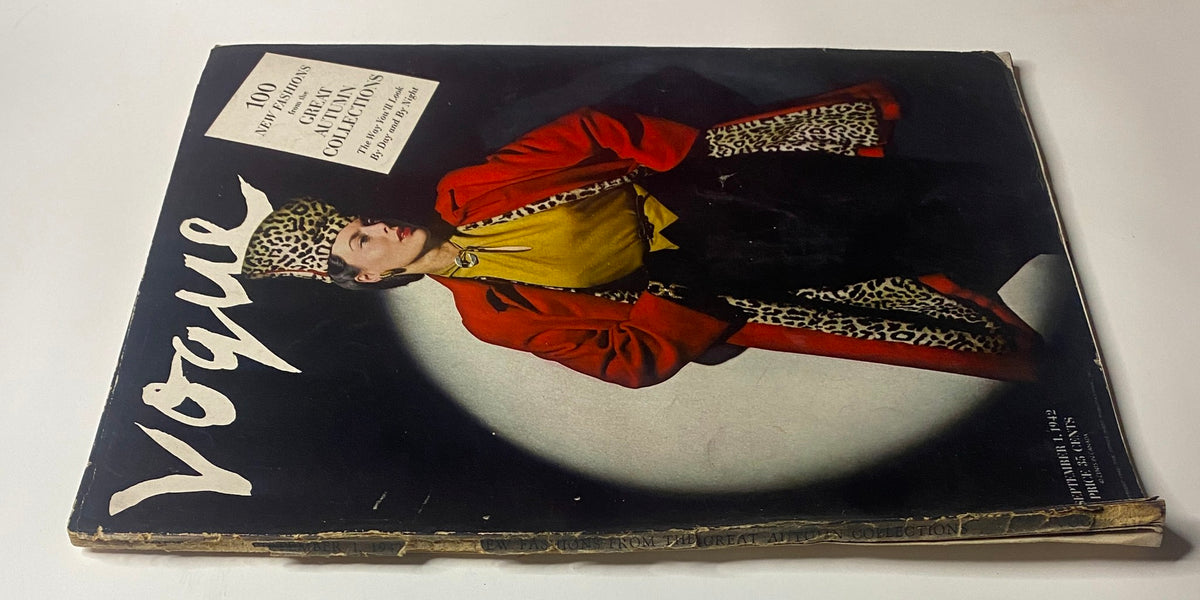 Alternative view of the cover of Vogue Magazine September 1, 1942 featuring Meg Mundy by John Rawlings. The image highlights a model wearing a vibrant red coat and a leopard print hat, promoting the magazine's autumn collections.