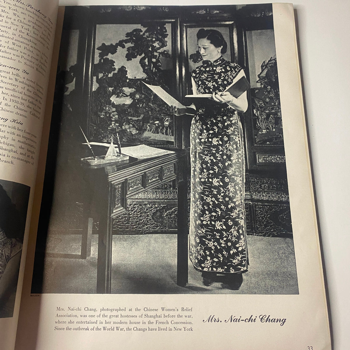 Portrait of Mrs. Nai-chi Chang, captured by Vogue Magazine June 1, 1942, showcasing her in a traditional Chinese dress in a richly decorated room.