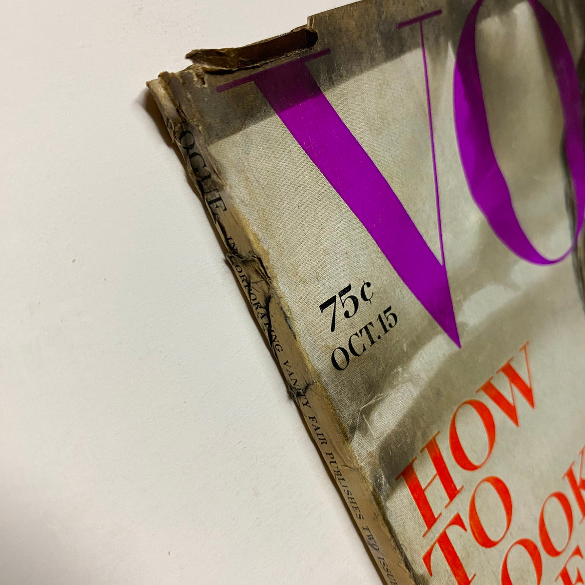 Side view of the Vogue Magazine October 15, 1969 cover, showing a partially worn spine and detailing the vintage state of the publication.