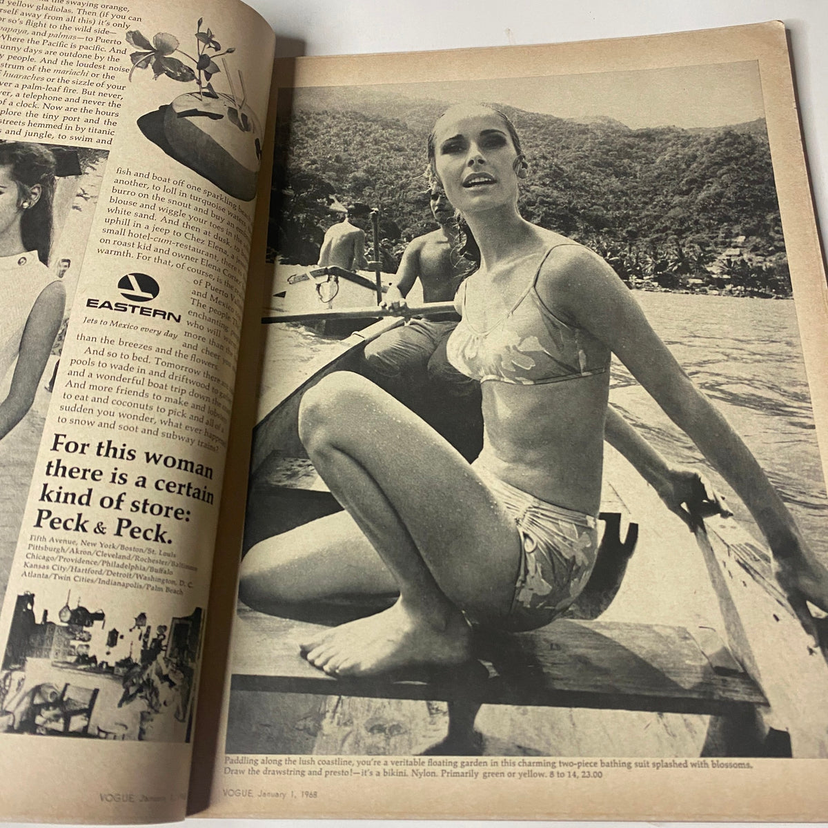 Vintage picture from Vogue Magazine January 1, 1968 featuring Sue Murray in a bikini, posing in a boat amidst a scenic backdrop, showcasing fashion from the era.