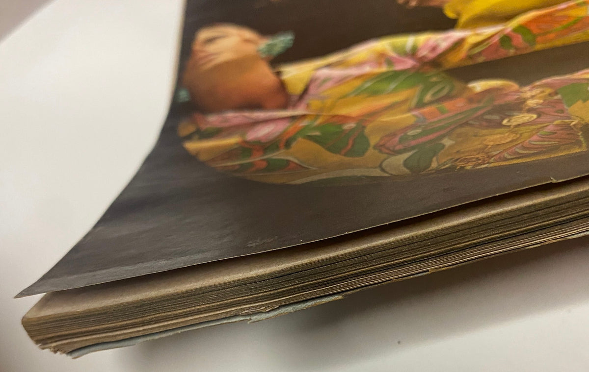 Detailed view of the spine of Vogue Magazine January 1, 1968, illustrating the age and charm of vintage fashion magazines from the 1960s era.