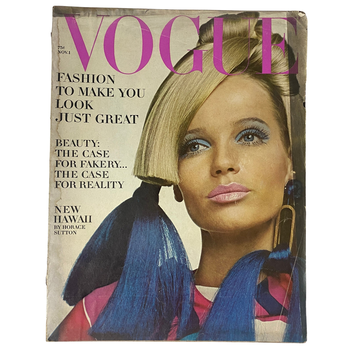 Cover of Vogue Magazine November 1, 1966 featuring Veruschka, model styled with bold, colorful hair accessories, and vibrant makeup, reflecting the era's fashion trends.