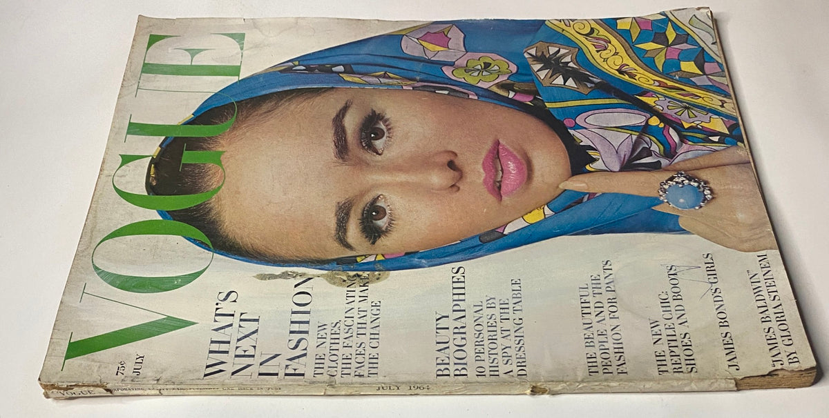 Close-up view of Vogue Magazine July 1964 cover, depicting Sondra Peterson styled by Irving Penn, emphasizing colorful attire and elegant accessories, representing a significant fashion era.
