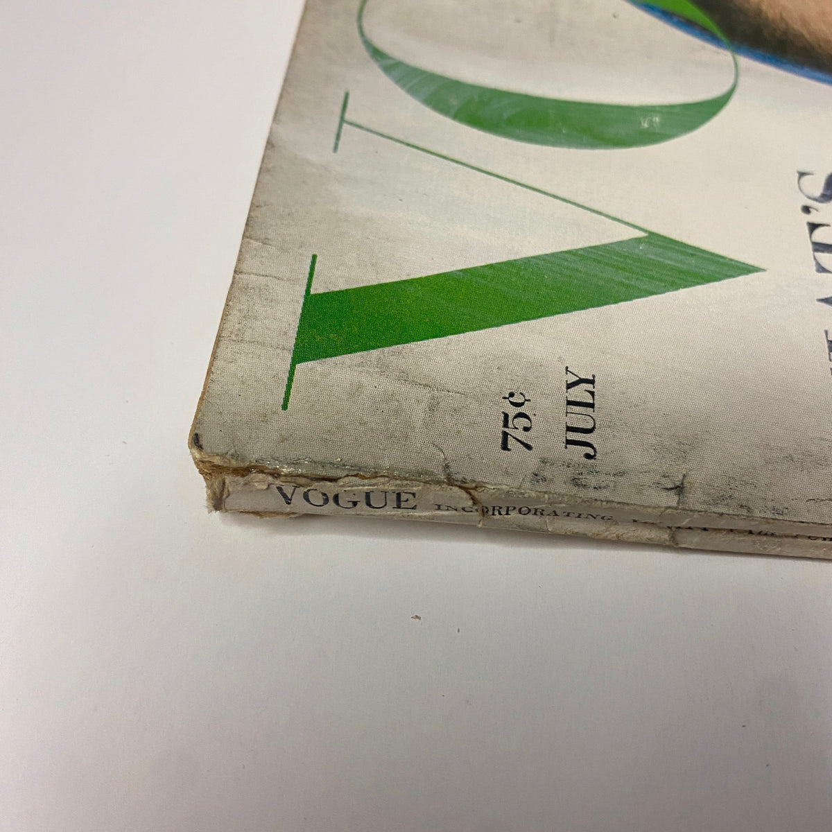 Detail shot of the spine of Vogue Magazine July 1964, confirming publication details and original branding, vital for collectors and enthusiasts of mid-century fashion magazines.