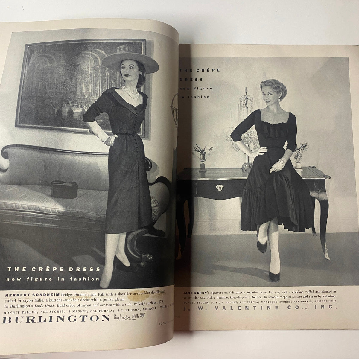 Advertisement pages from Vogue Magazine July 1952 featuring fashionable dresses. Highlights mid-century style alongside the magazine's Ruth Neumann cover by Irving Penn.