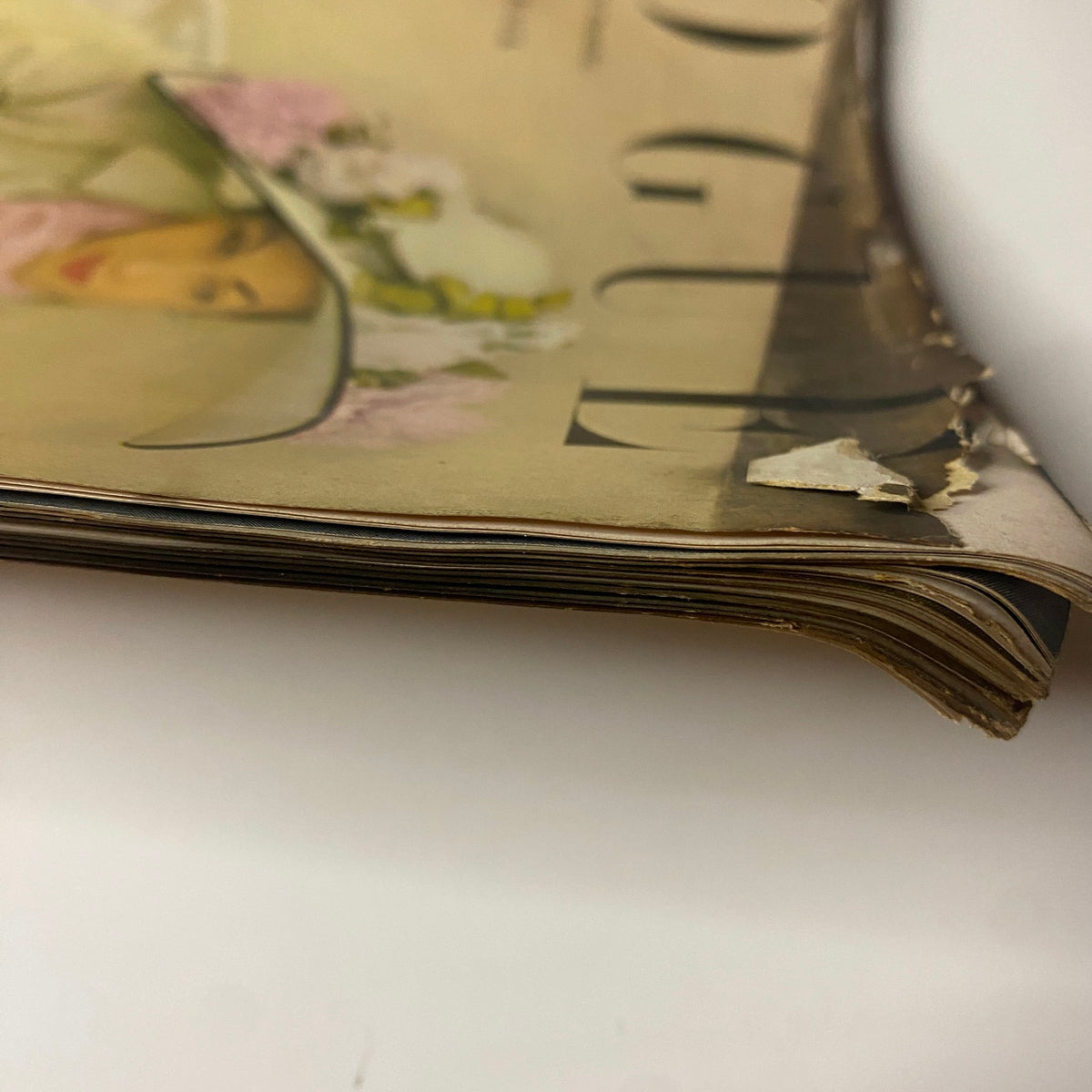 Side view of Vogue Magazine April 15, 1948 showing the slightly damaged spine and paper edges, reflecting its vintage status and historical significance.