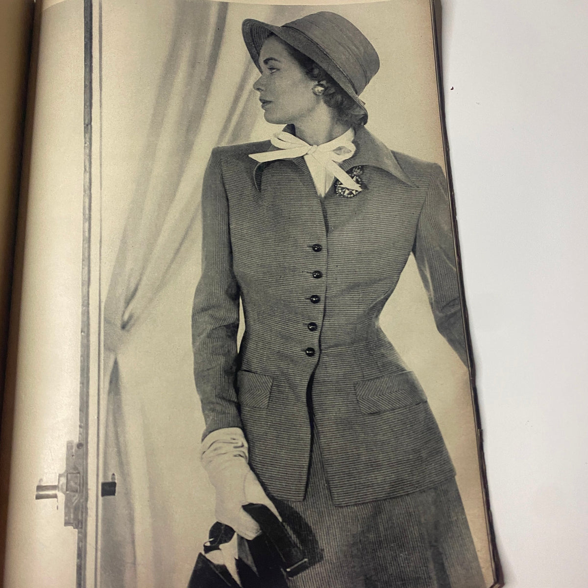 Vogue Magazine April 15, 1948 displaying a stylish photograph of a woman modeling a tailored suit with a hat, embodying the refined fashion trends of the 1940s.