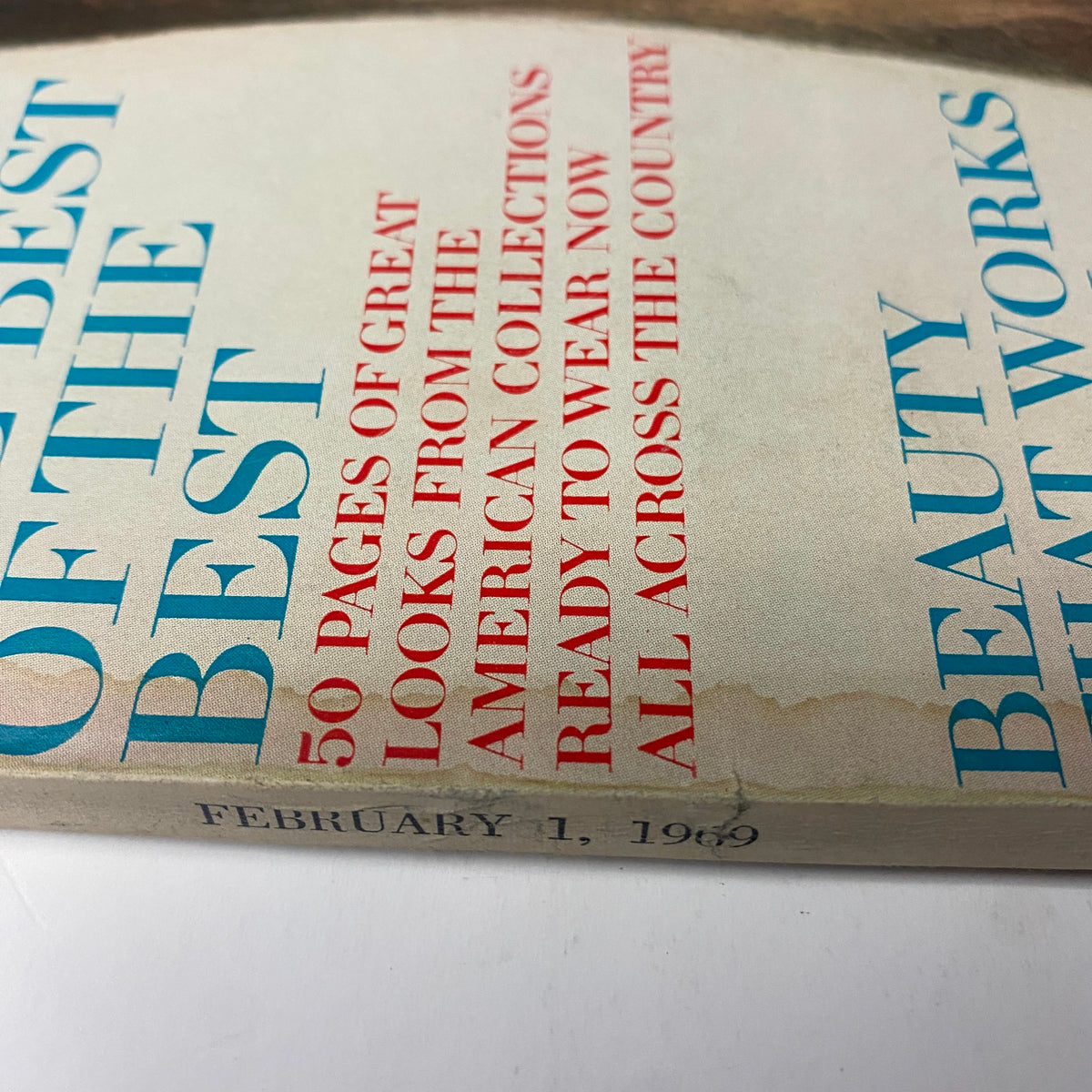 Close-up of the spine and cover edge of Vogue Magazine February 1, 1969 featuring in blue and red text, showcasing vintage wear indicative of its age.