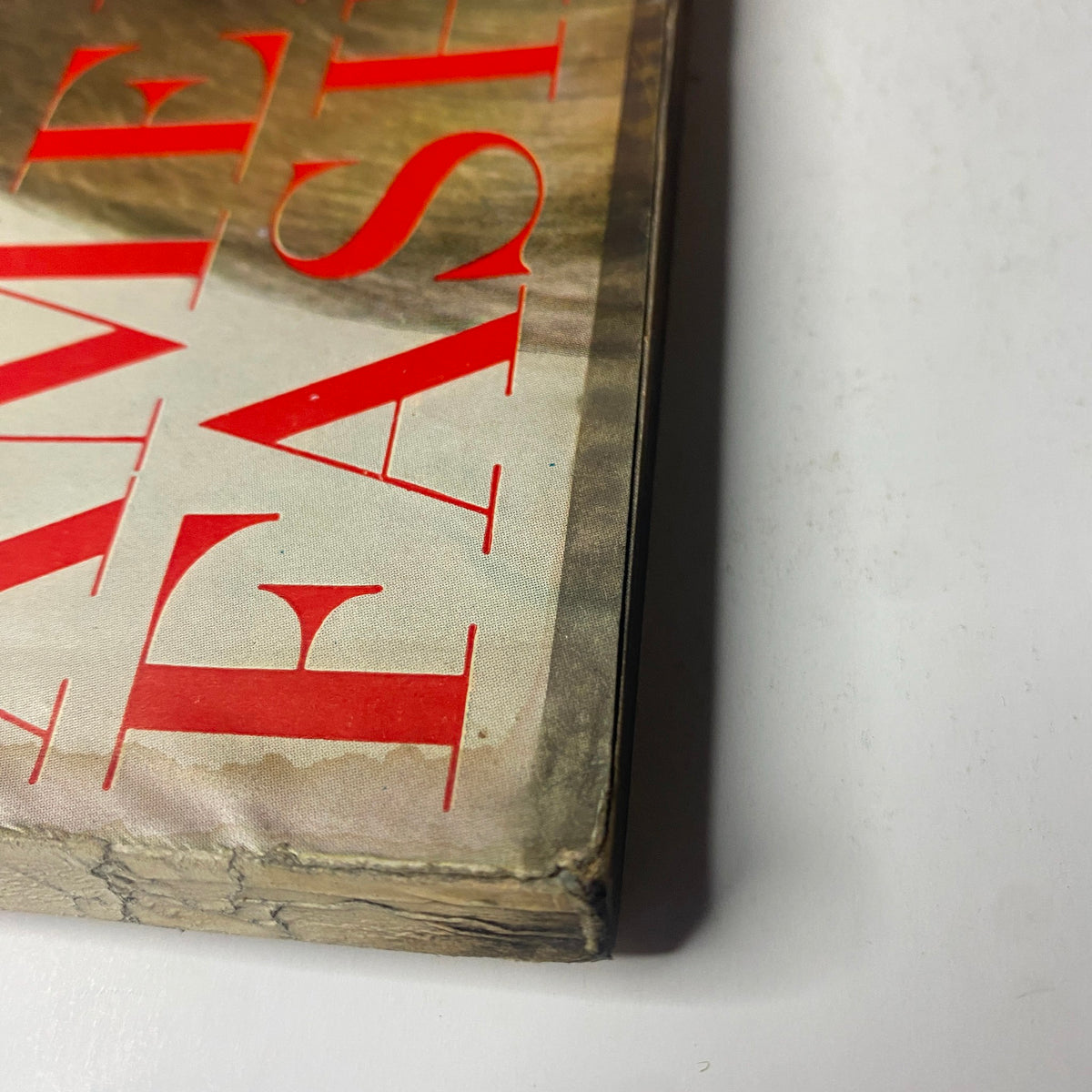Detailed view of the corner of Vogue Magazine February 1, 1969 displaying wear and tear along the edges, emphasizing the magazine's vintage characteristics.