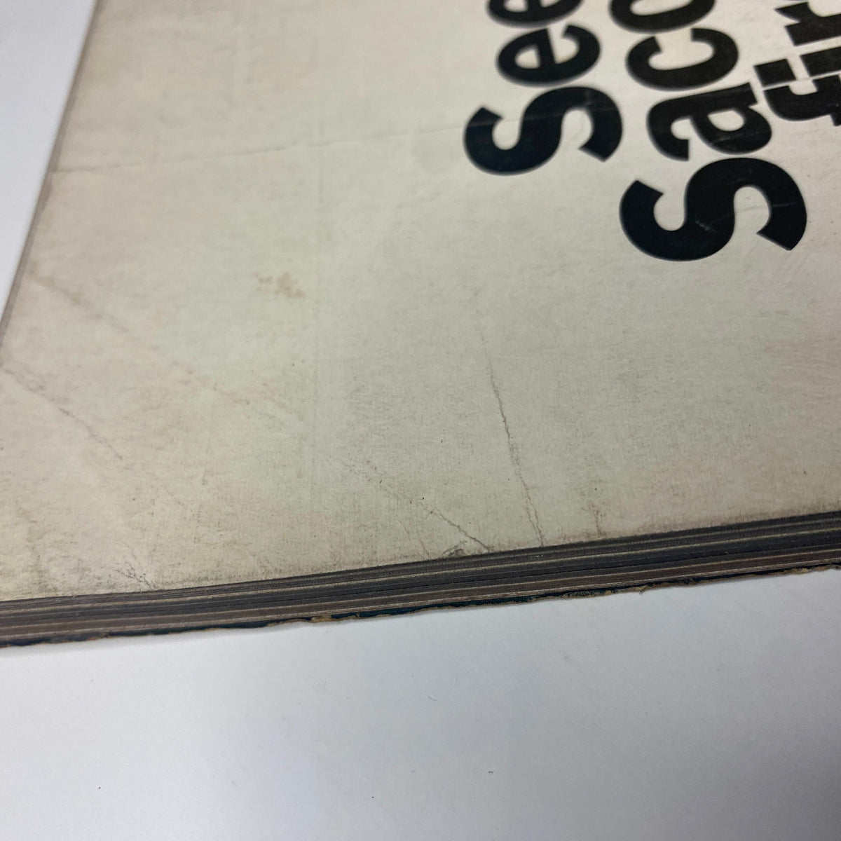 Side view of Vogue Magazine February 1, 1969, displaying the vintage condition and subtle aging around the edges, which adds character to this collectible item.
