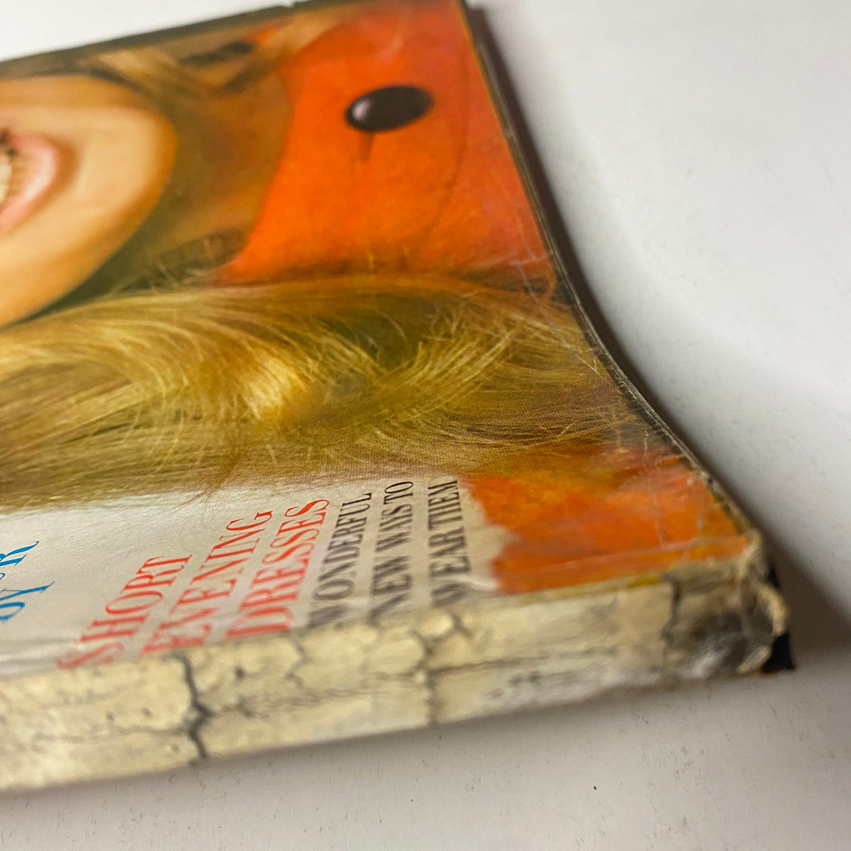 Detailed view of the cover corner of Vogue Magazine October 1, 1969 Jean Shrimpton Cover by Bert Stern, showcasing the magazine’s wear and distinct vintage characteristics, including the iconic orange color.