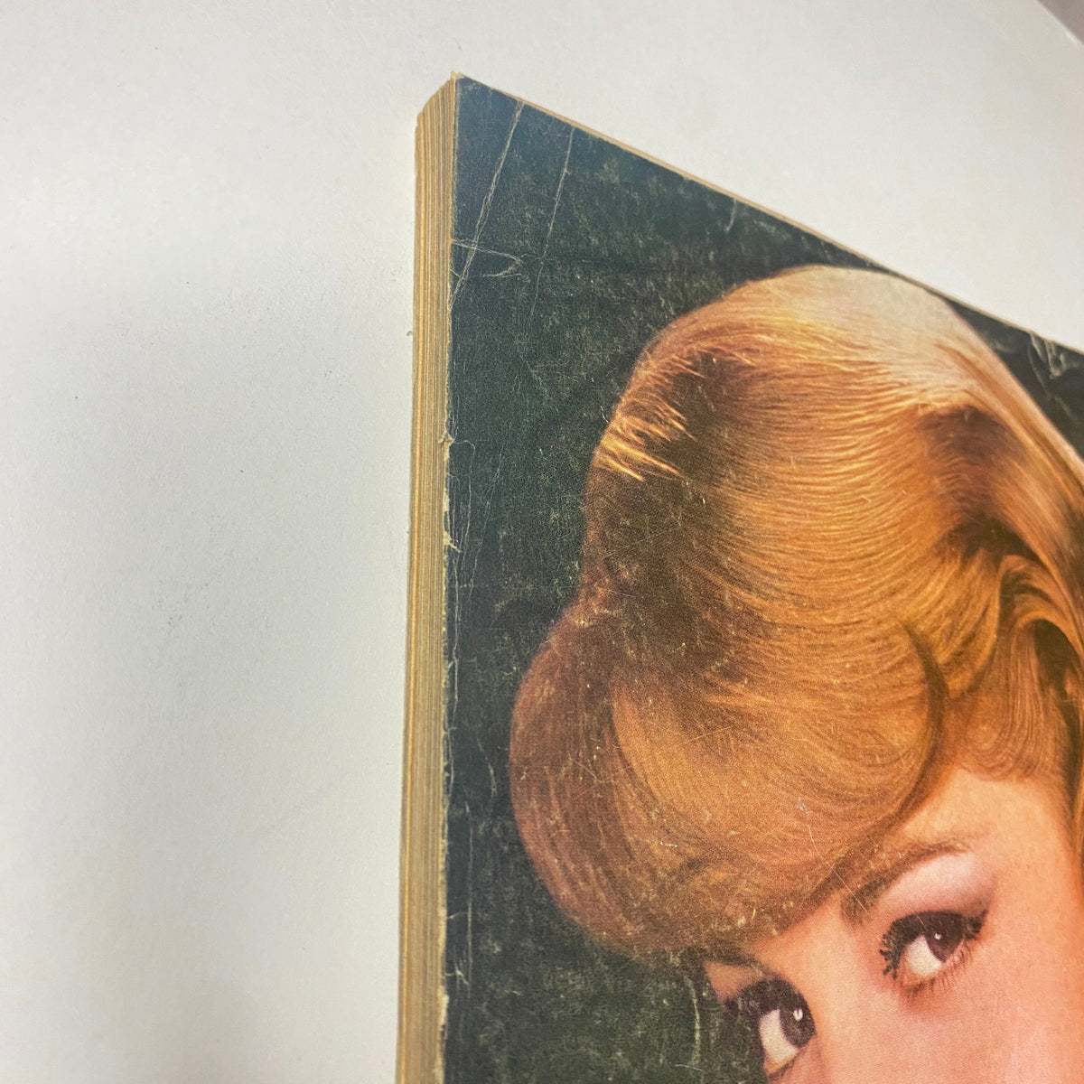 Detailed view of the edge of the October 1, 1964 Vogue Magazine, featuring slightly worn pages that reflect its age and vintage nature.
