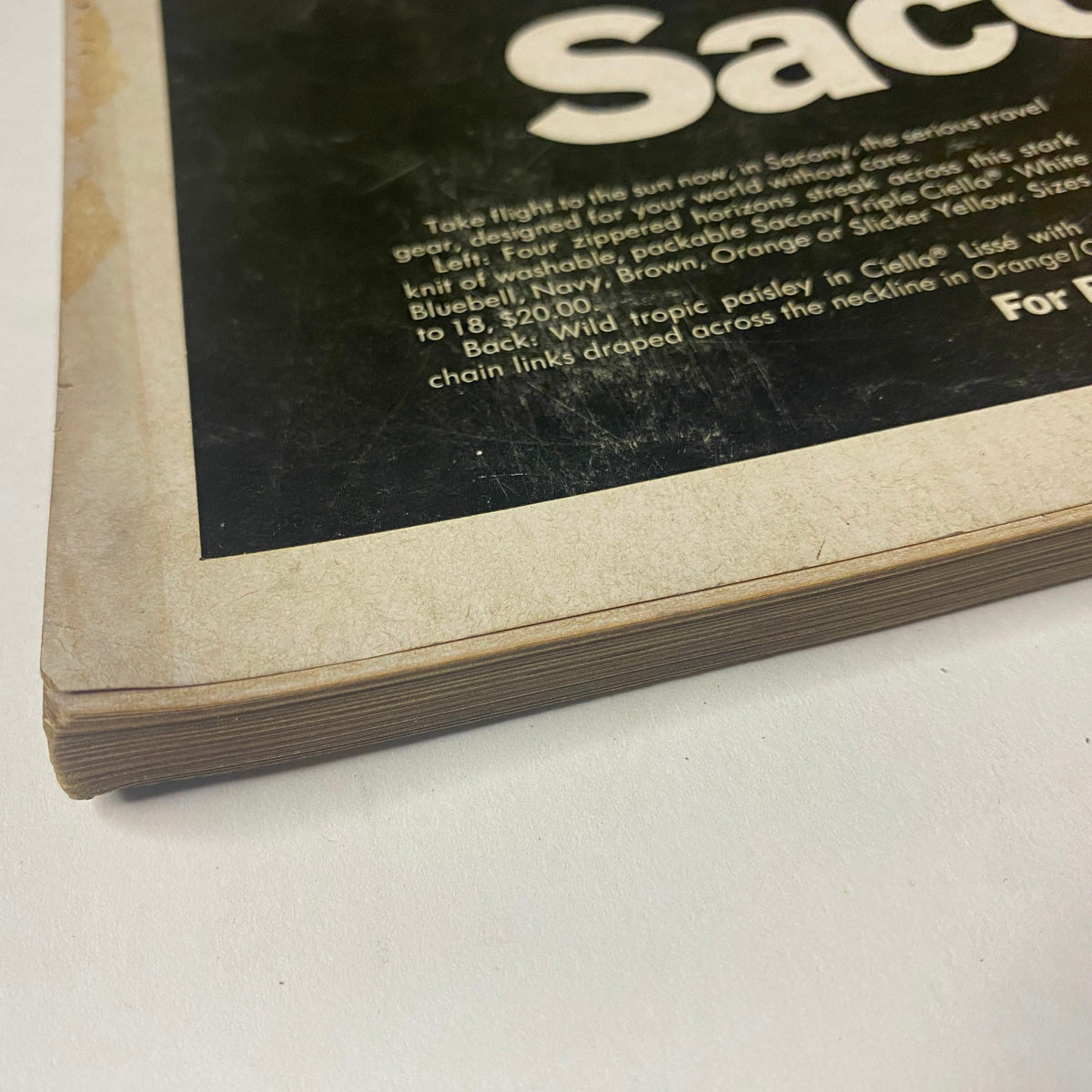 Close-up shot of the spine of Vogue Magazine February 1, 1968, showing vintage wear and characteristic signs of age, emphasizing its collectible condition.