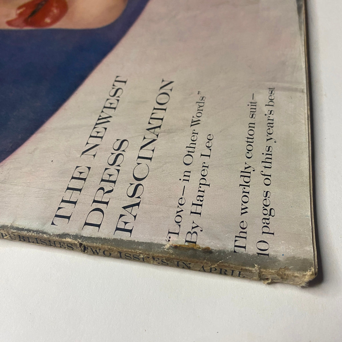Detailed view of the cover of Vogue Magazine April 15, 1961, showcasing the title and promotional content including articles by Harper Lee.