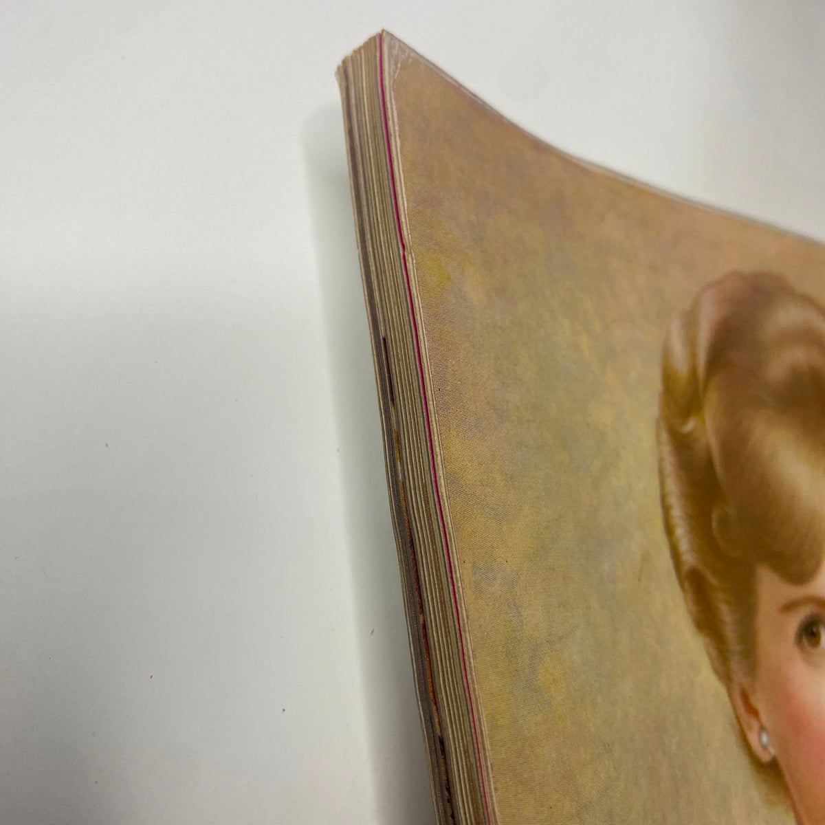 Detail of the spine of Vogue Magazine displaying the aging effects and vintage condition of the publication. Original Vogue Magazine December 1961 Antonia Boekestyn Cover by Horst P. Horst.