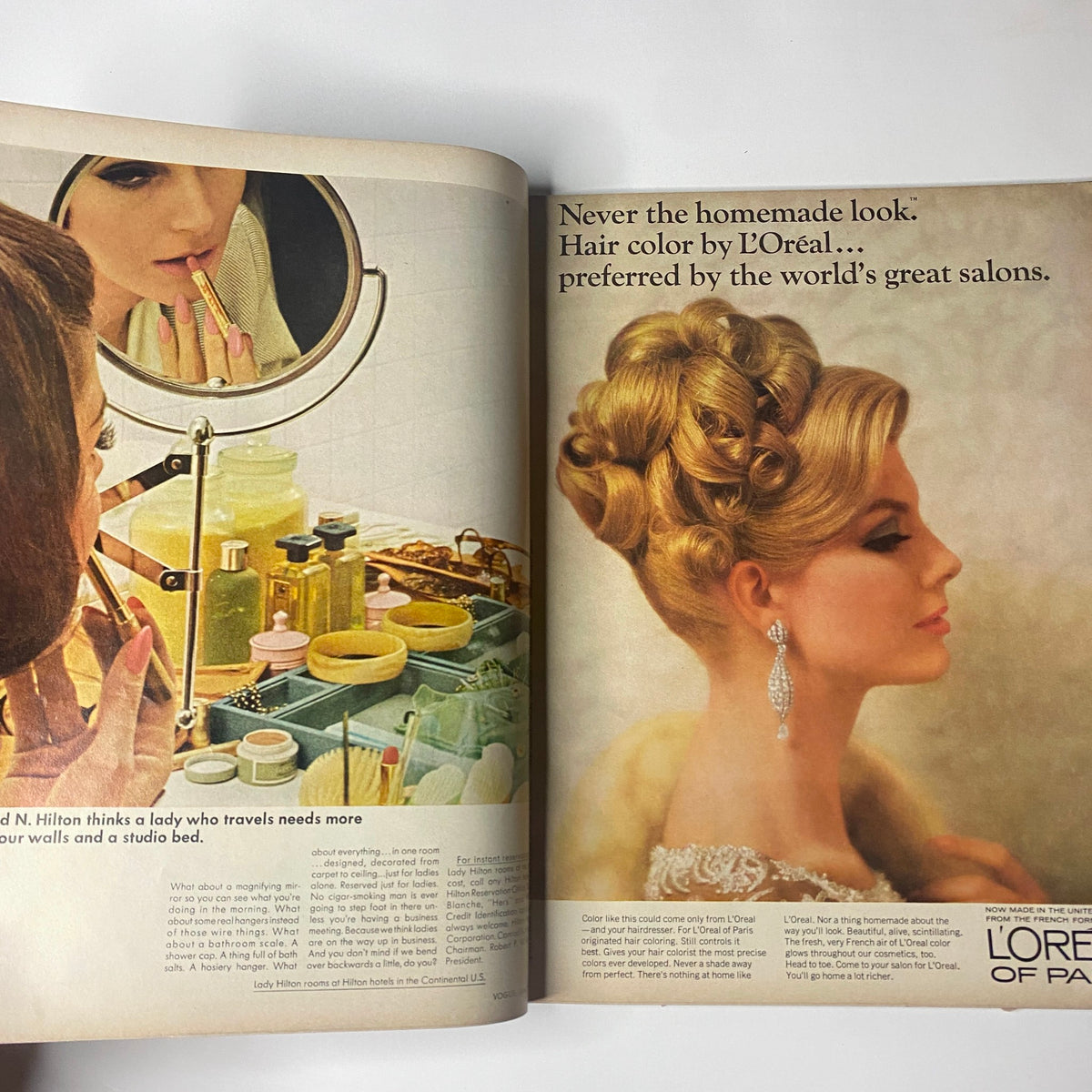Vogue Magazine June 1965 – Brigitte Bauer Cover by Irving Penn. An advertisement showcasing hair color by L'Oréal, featuring a glamorous hairstyle and woman applying lipstick in a stylish vanity setting, reflecting the beauty standards of the 1960s.