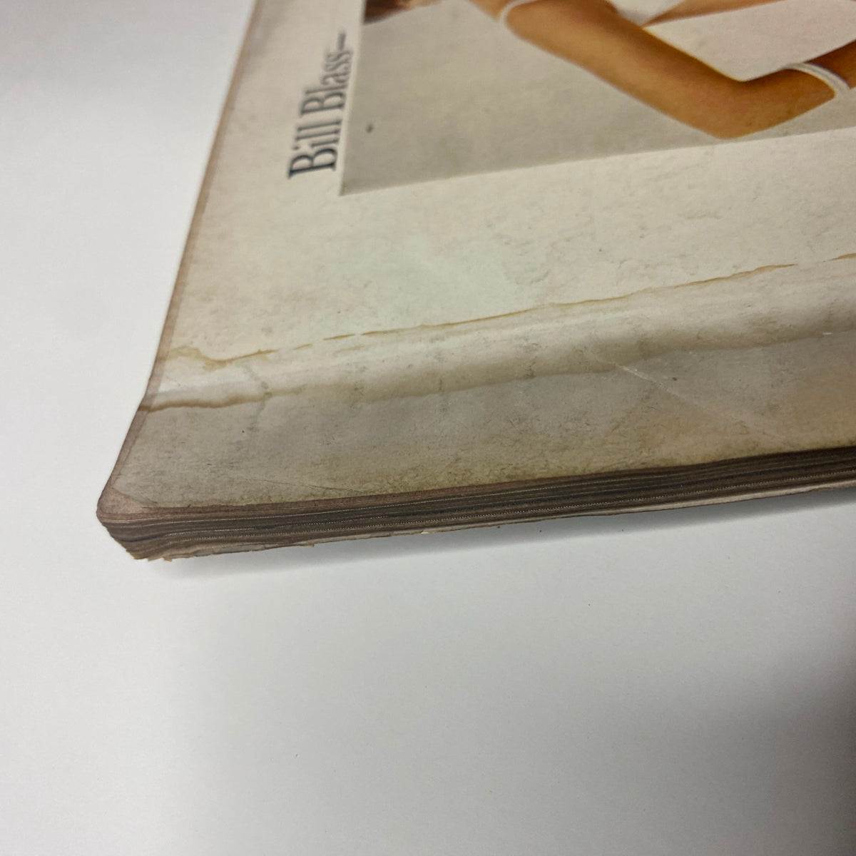 Vogue Magazine June 1965 – Brigitte Bauer Cover by Irving Penn. A detailed image of the magazine’s bottom edge showing signs of wear and age, emphasizing its vintage quality and longstanding preservation.