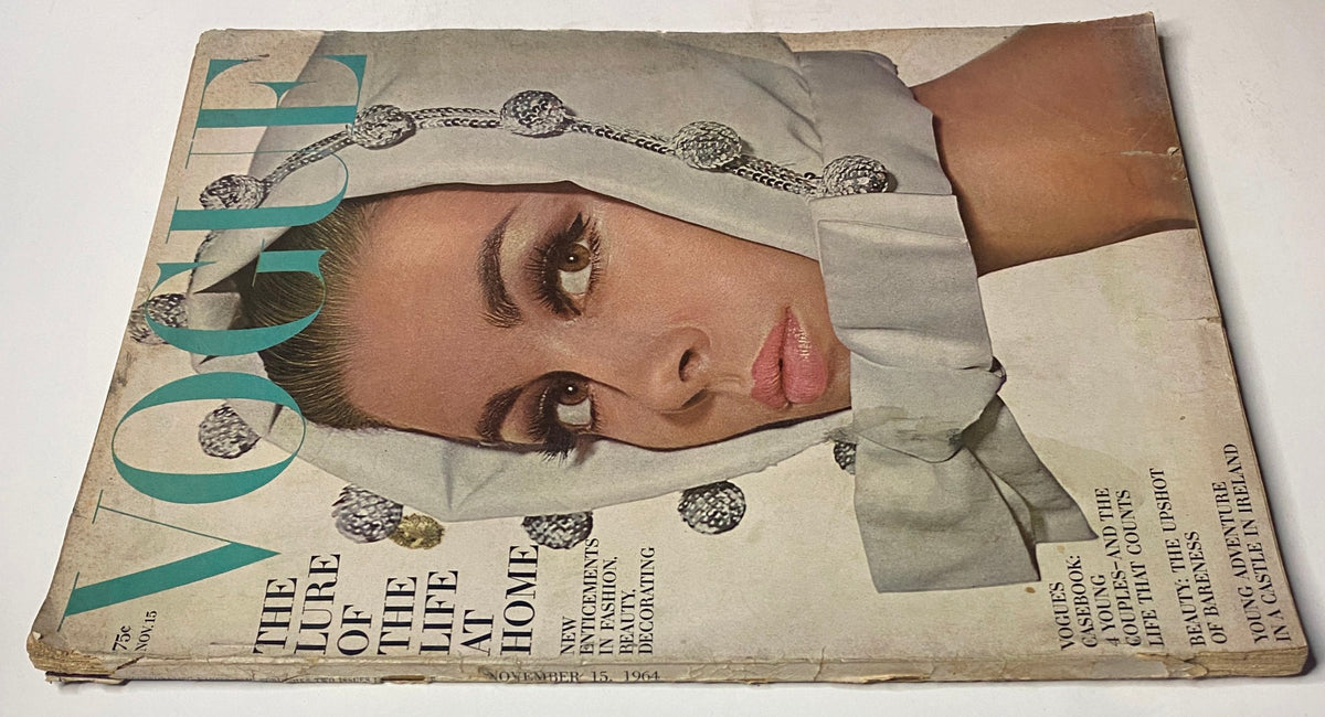 Vogue Magazine November 15, 1964 cover featuring Astrid Heeren, photographed by Irving Penn, showcasing bold makeup and an elegant headscarf.
