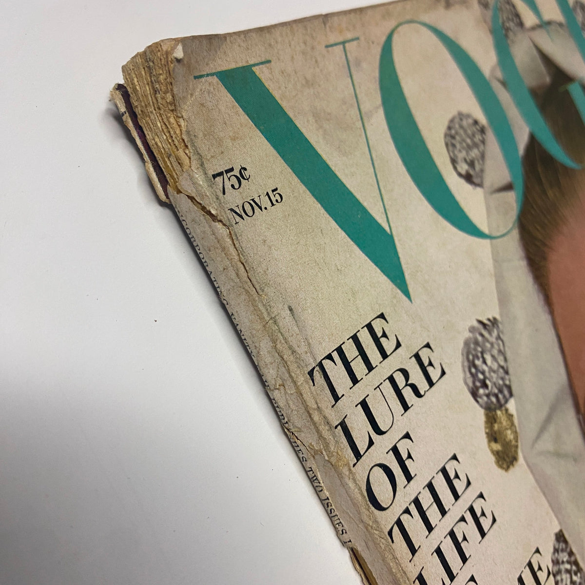 Close-up of the torn edge of the Vogue Magazine November 15, 1964 issue, highlighting signs of vintage wear and its unique character.