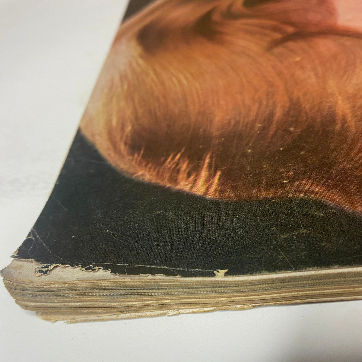 Side view of a vintage Vogue Magazine November 15, 1964, highlighting worn edges, characteristic of a well-preserved collectible magazine from the 1960s.