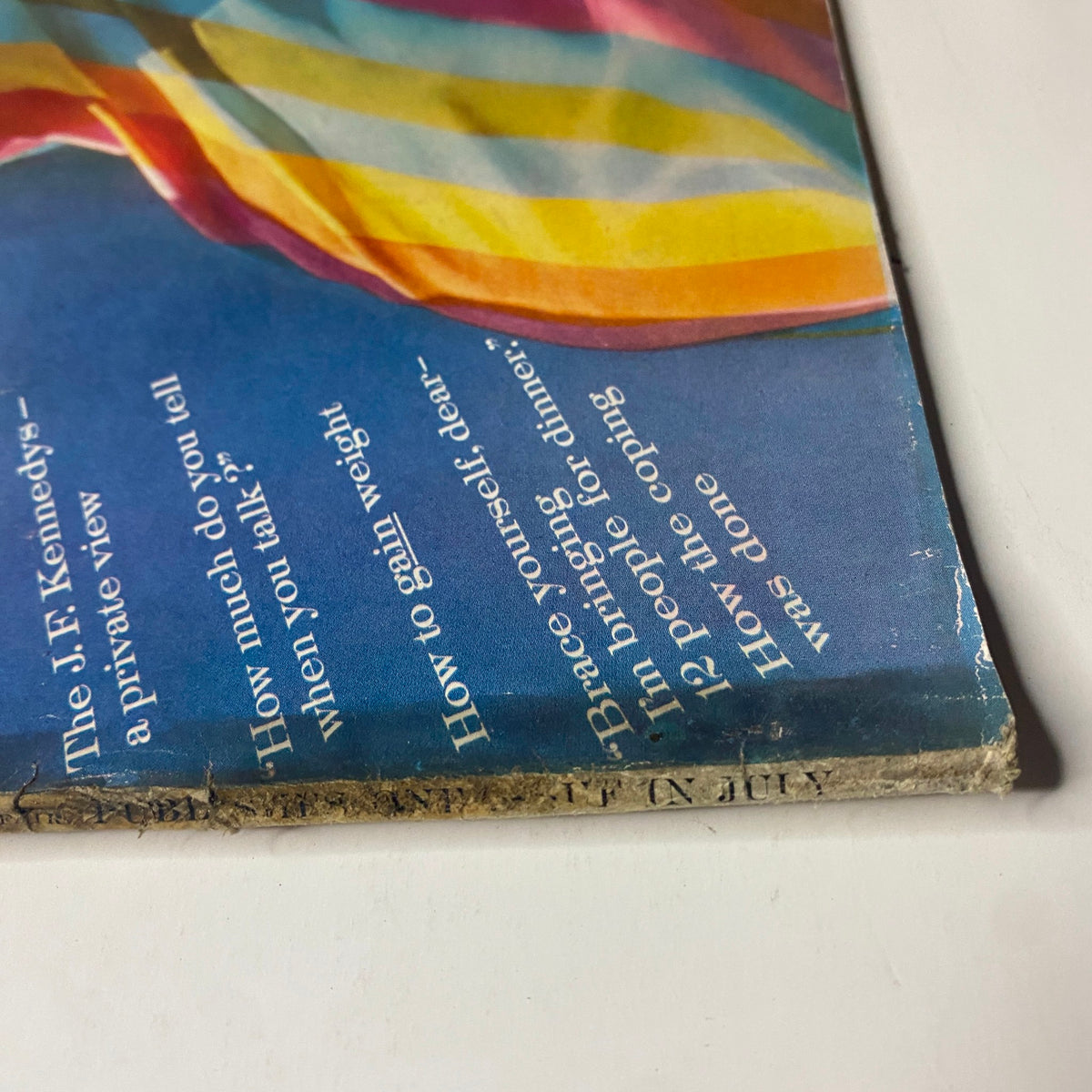 Side view of Vogue Magazine July 1961 showing the colorful cover featuring Deborah Dixon, illustrating vintage magazine condition and charm.