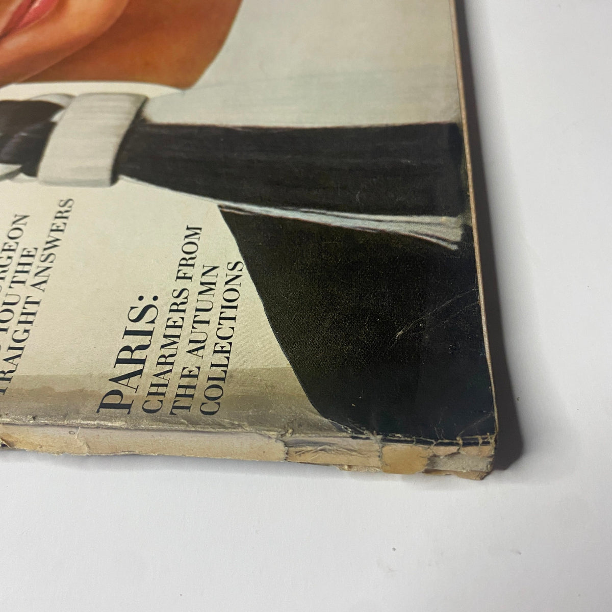 Detailed view of the bottom corner of Vogue Magazine September 15, 1966, emphasizing the magazine’s age with visible wear conditions and the cover image of Brigitte Bauer by Richard Avedon.