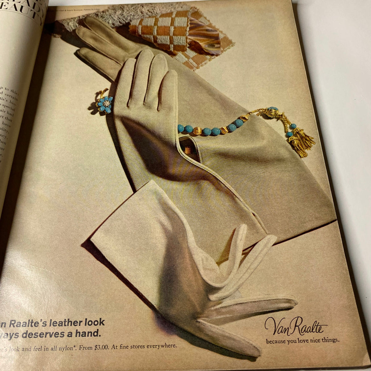 Vogue Magazine March 1, 1966 features a close-up advertisement for Van Raalte's leather-look gloves, showcasing elegant styling with accessory details.