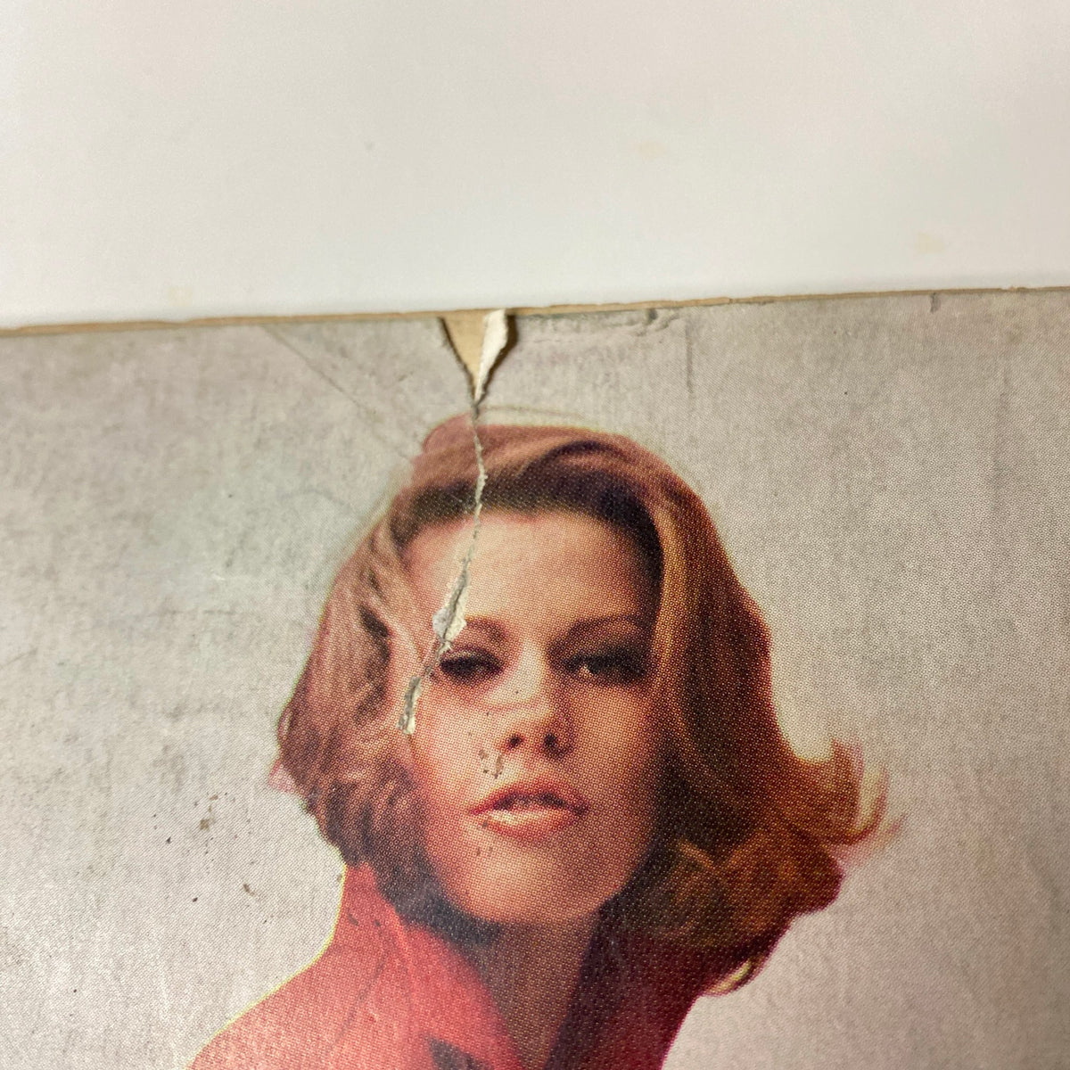 Vogue Magazine March 1, 1966 highlights a vintage fashion shot of a model with tousled hair, wearing a red garment, emphasizing the timeless appeal of 1960s style.