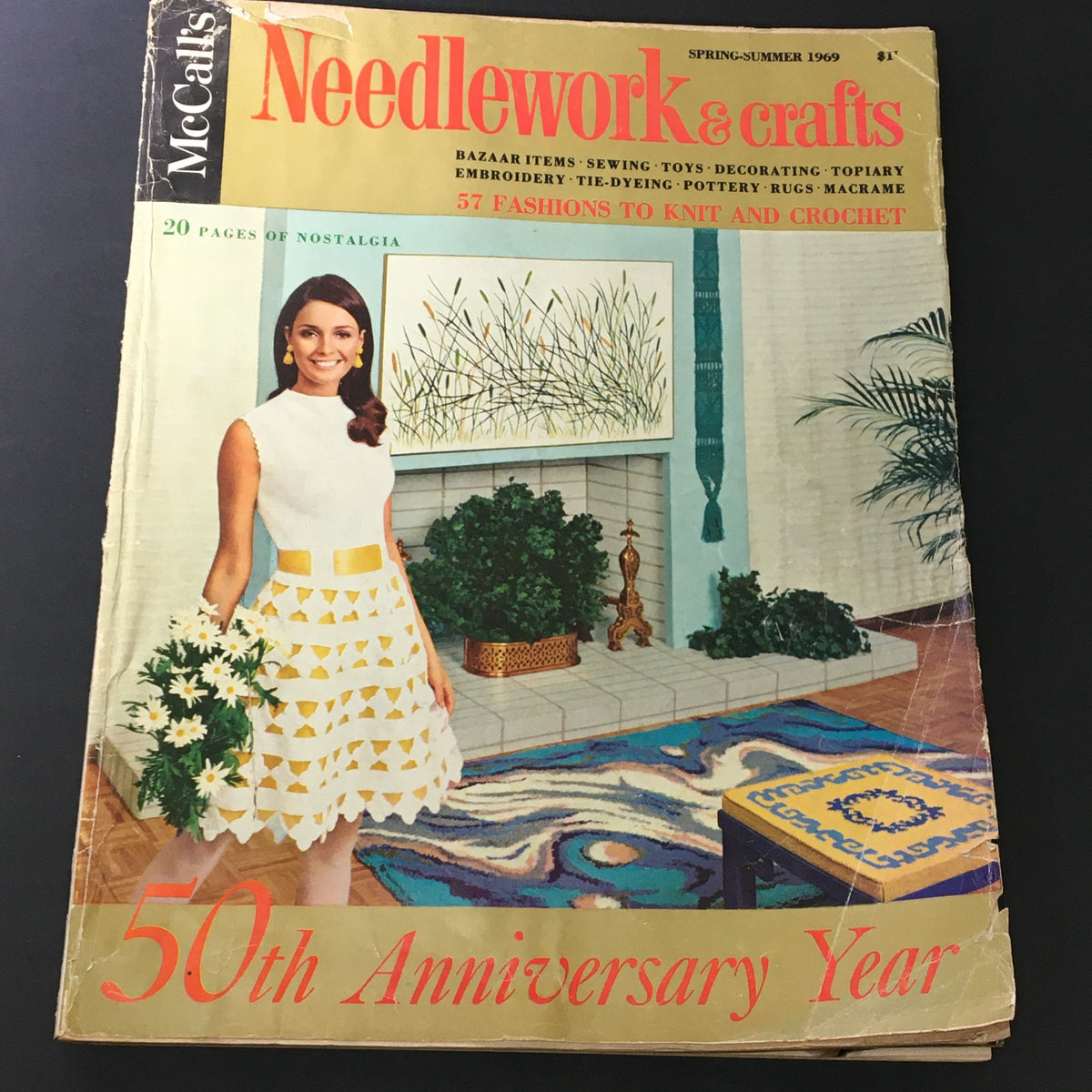 Cover of VTG McCall's Needlework & Crafts Magazine Spring Summer 1969 featuring a woman in a stylish outfit with a bouquet of flowers, highlighting crafting and needlework themes.